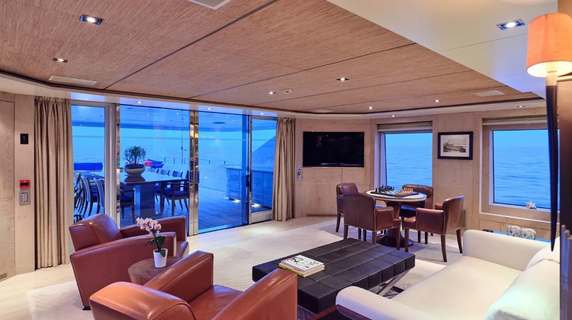 a living room with a large window aboard TIMBUKTU Yacht for Charter