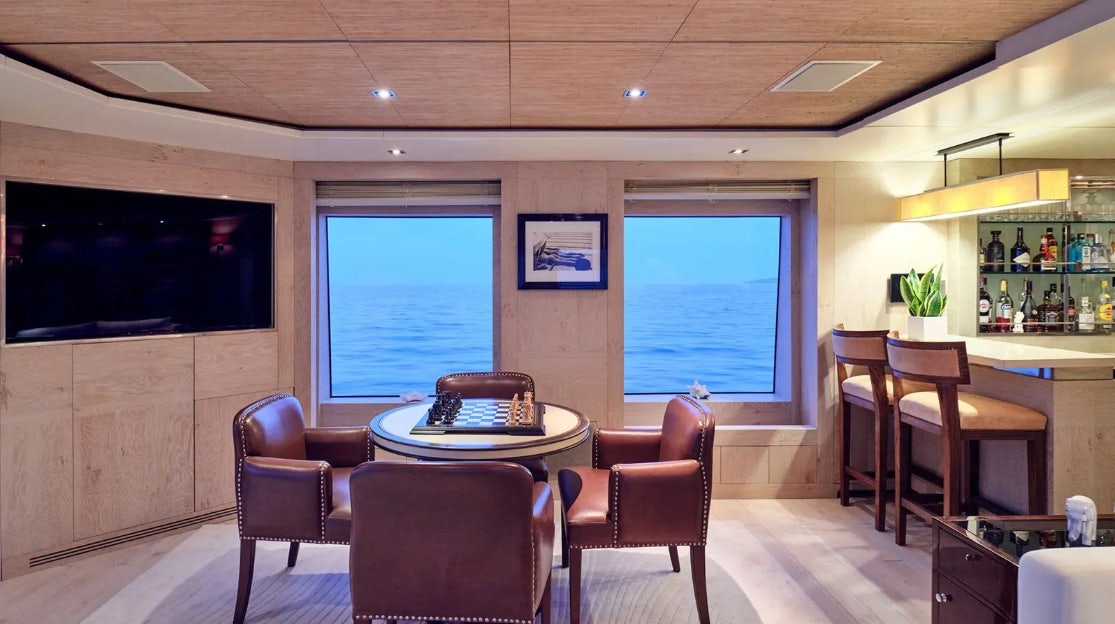 a room with a table and chairs aboard TIMBUKTU Yacht for Charter