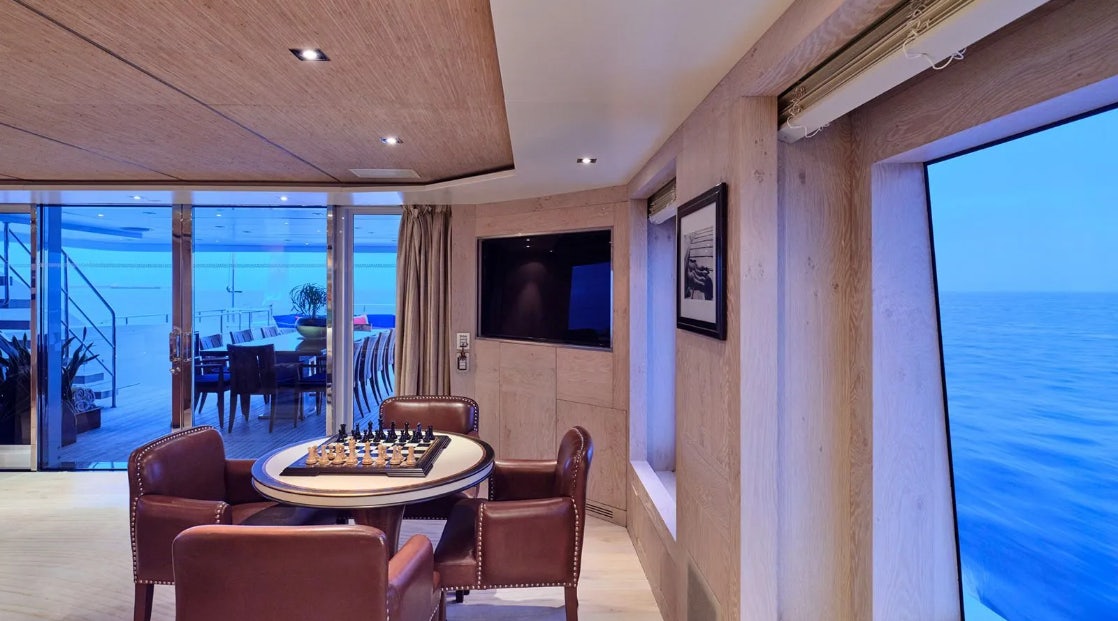 a room with a table and chairs aboard TIMBUKTU Yacht for Charter