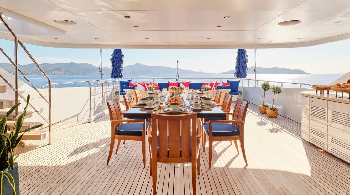 a table and chairs on a deck aboard TIMBUKTU Yacht for Charter