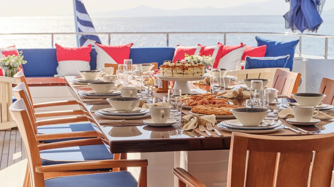 a table with food and drinks on it aboard TIMBUKTU Yacht for Charter