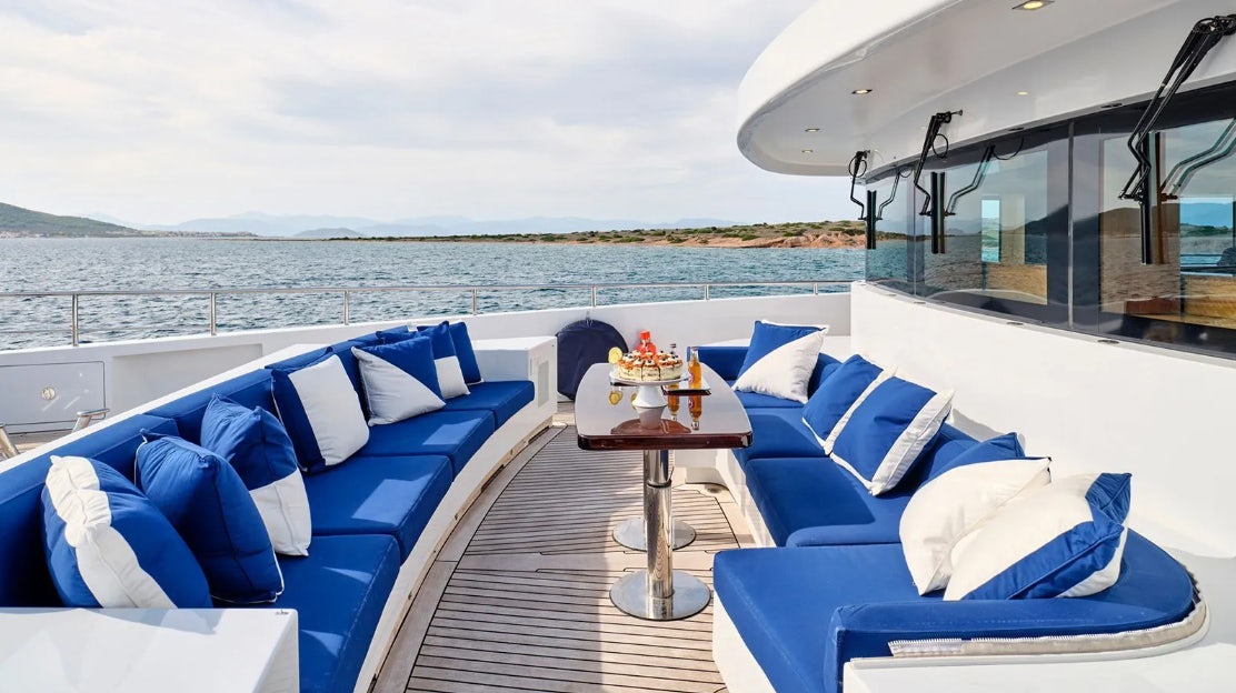 a room with a table and chairs aboard TIMBUKTU Yacht for Charter