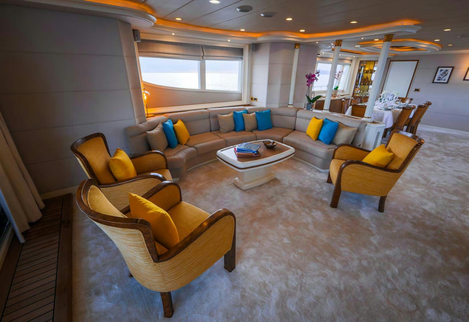 a living room with a couch and a coffee table aboard VIKING III Yacht for Sale