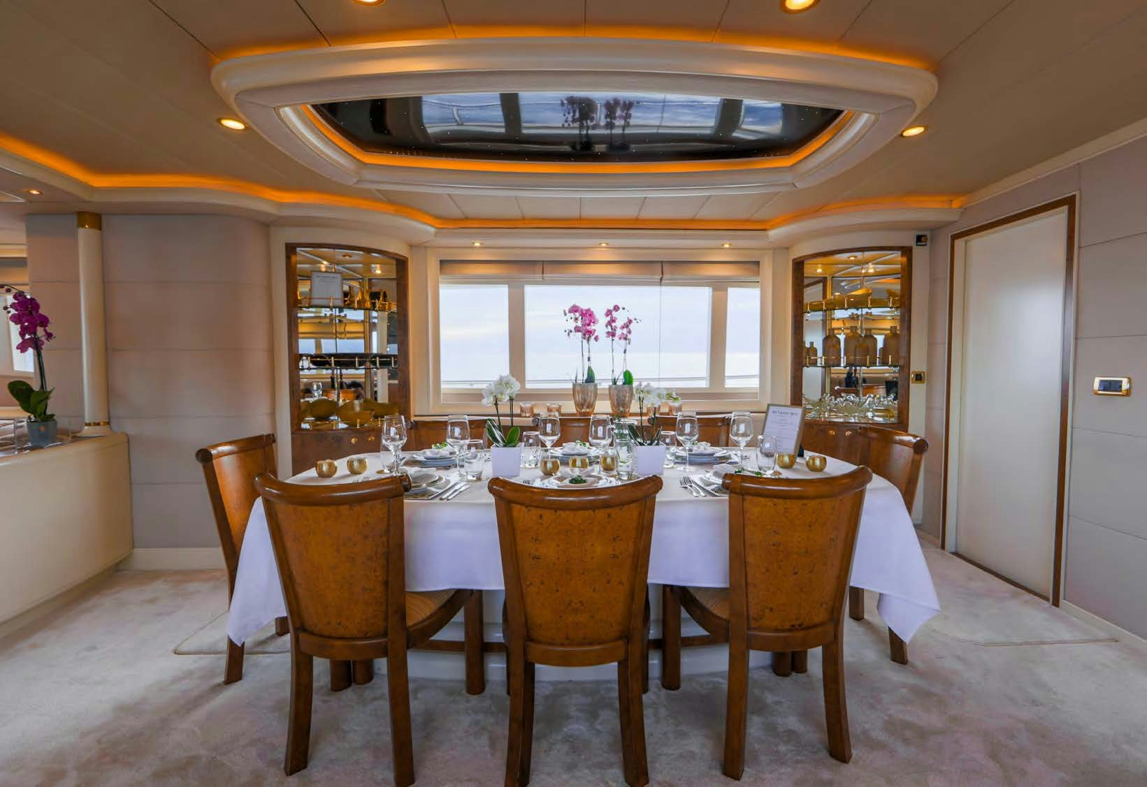 a dining table set for a dinner party aboard VIKING III Yacht for Sale