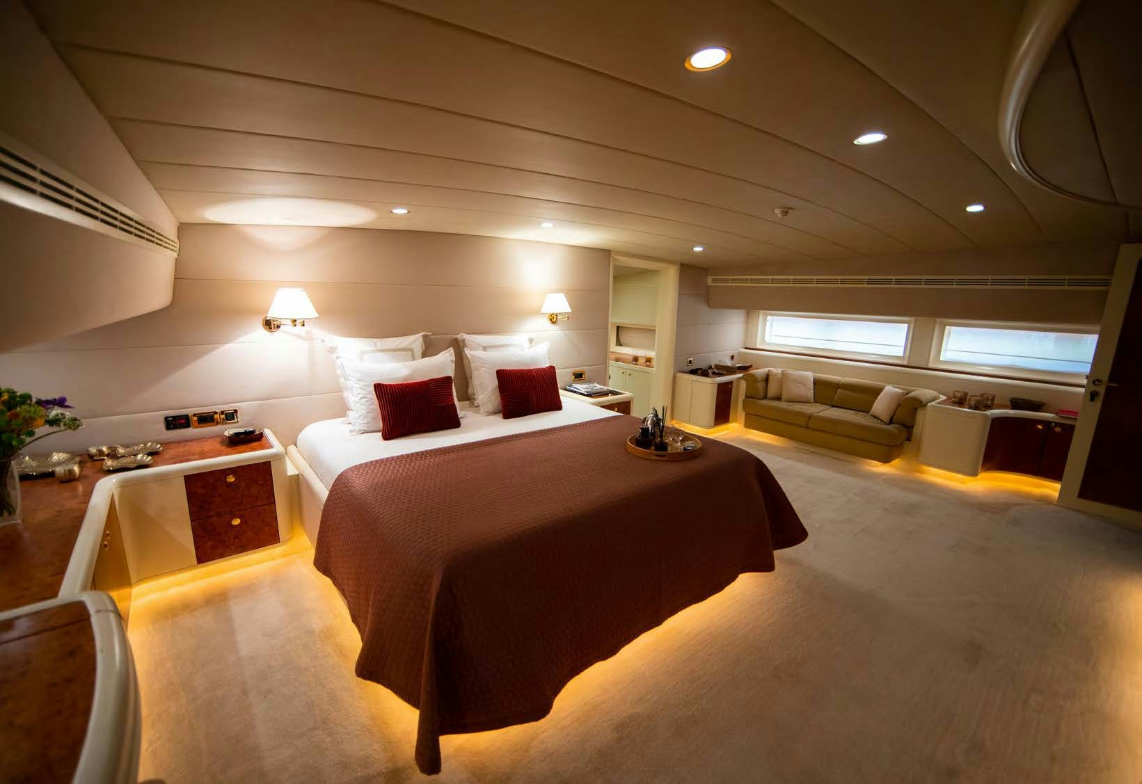 a room with a bed and a couch aboard VIKING III Yacht for Sale