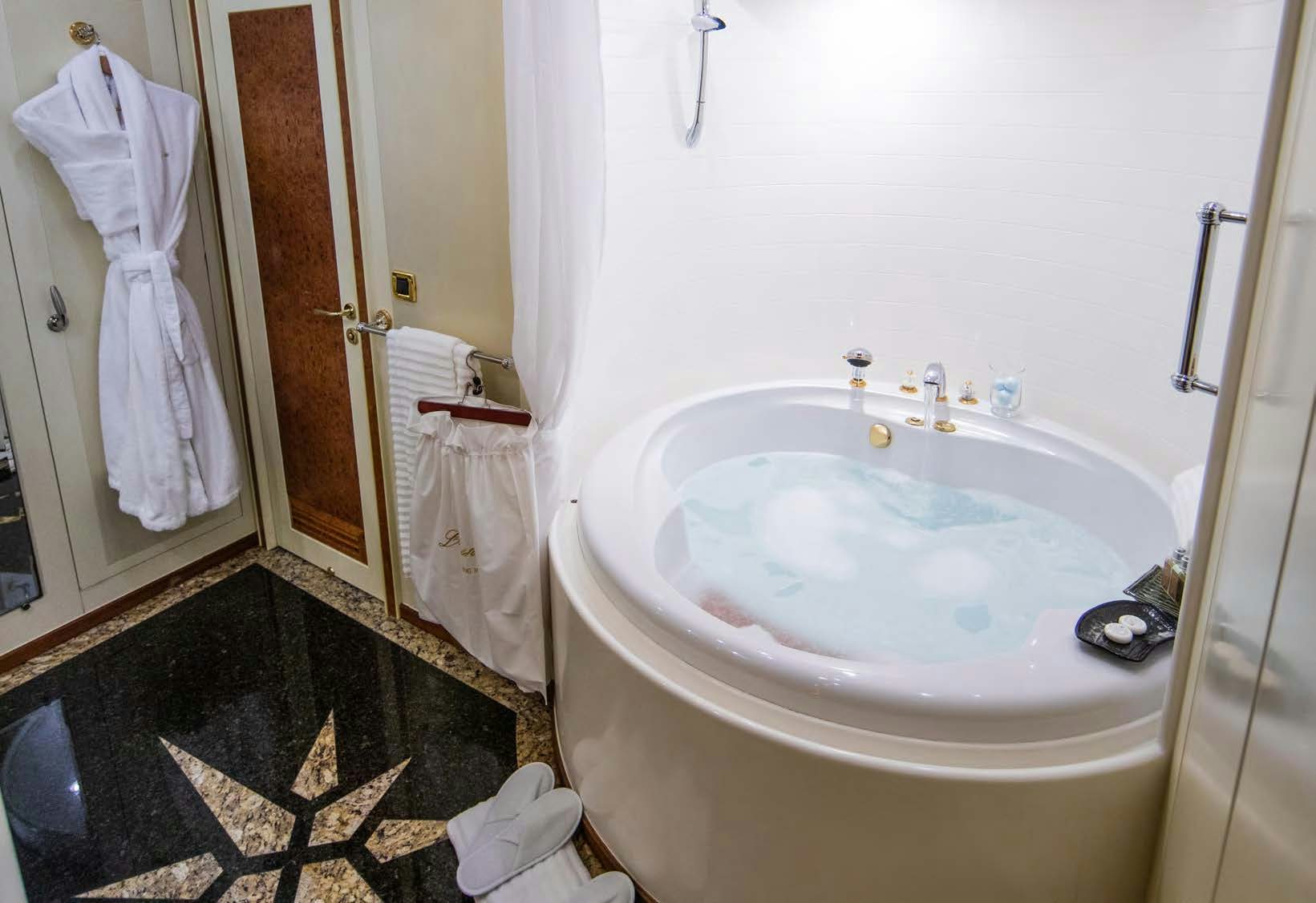 a bathroom with a sink and a rug aboard VIKING III Yacht for Sale