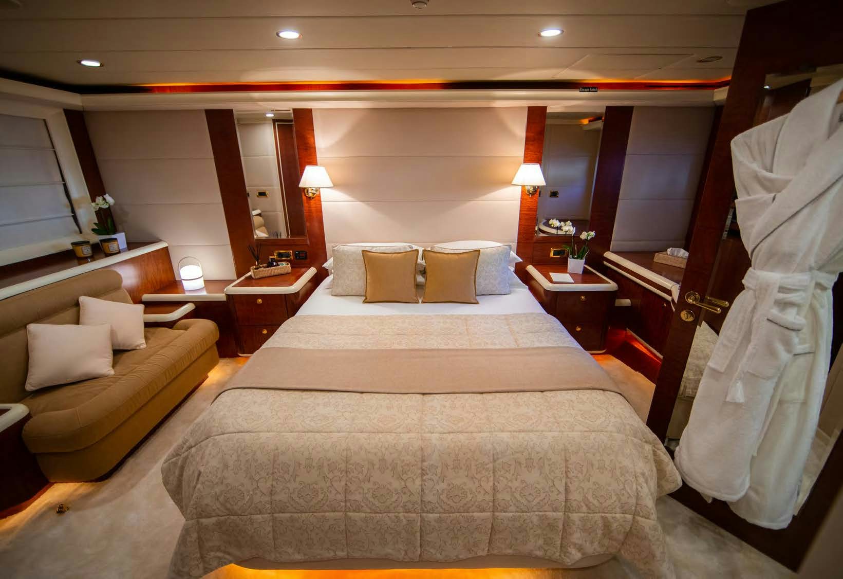 a hotel room with a bed and a couch aboard VIKING III Yacht for Sale