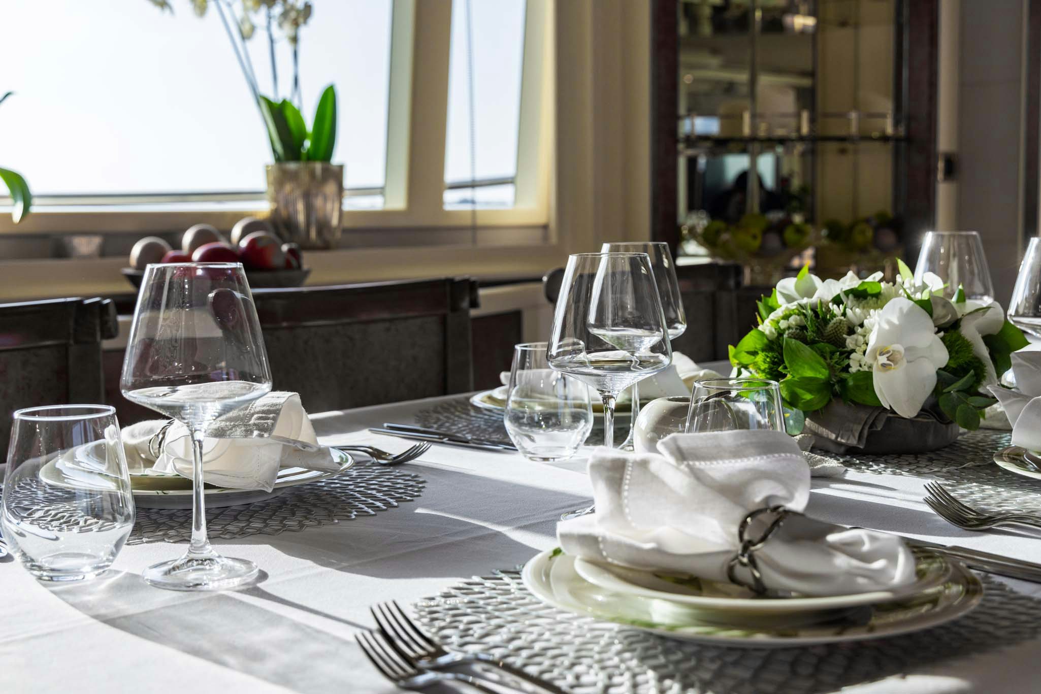 a table with plates and glasses aboard VIKING III Yacht for Charter