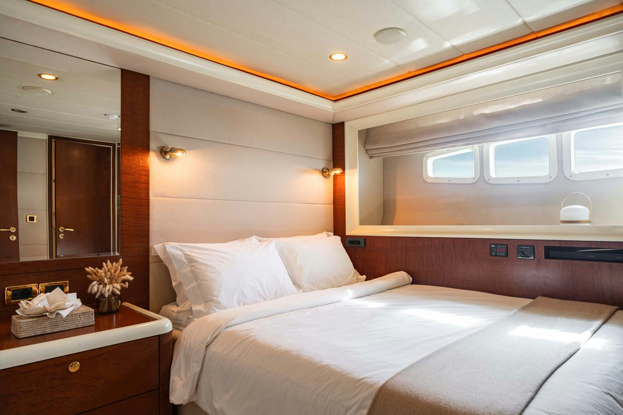 a room with a bed and a desk aboard VIKING III Yacht for Charter