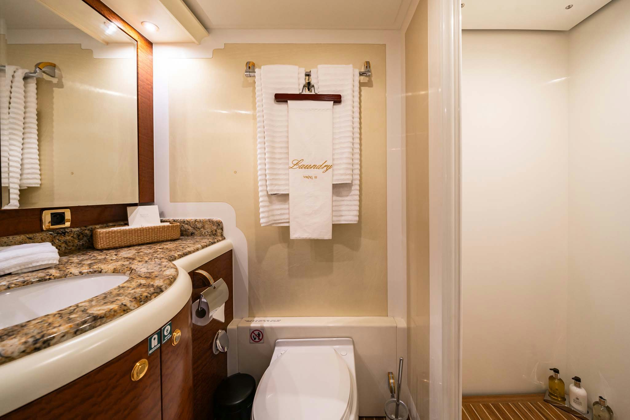 a bathroom with a sink and a toilet aboard VIKING III Yacht for Charter