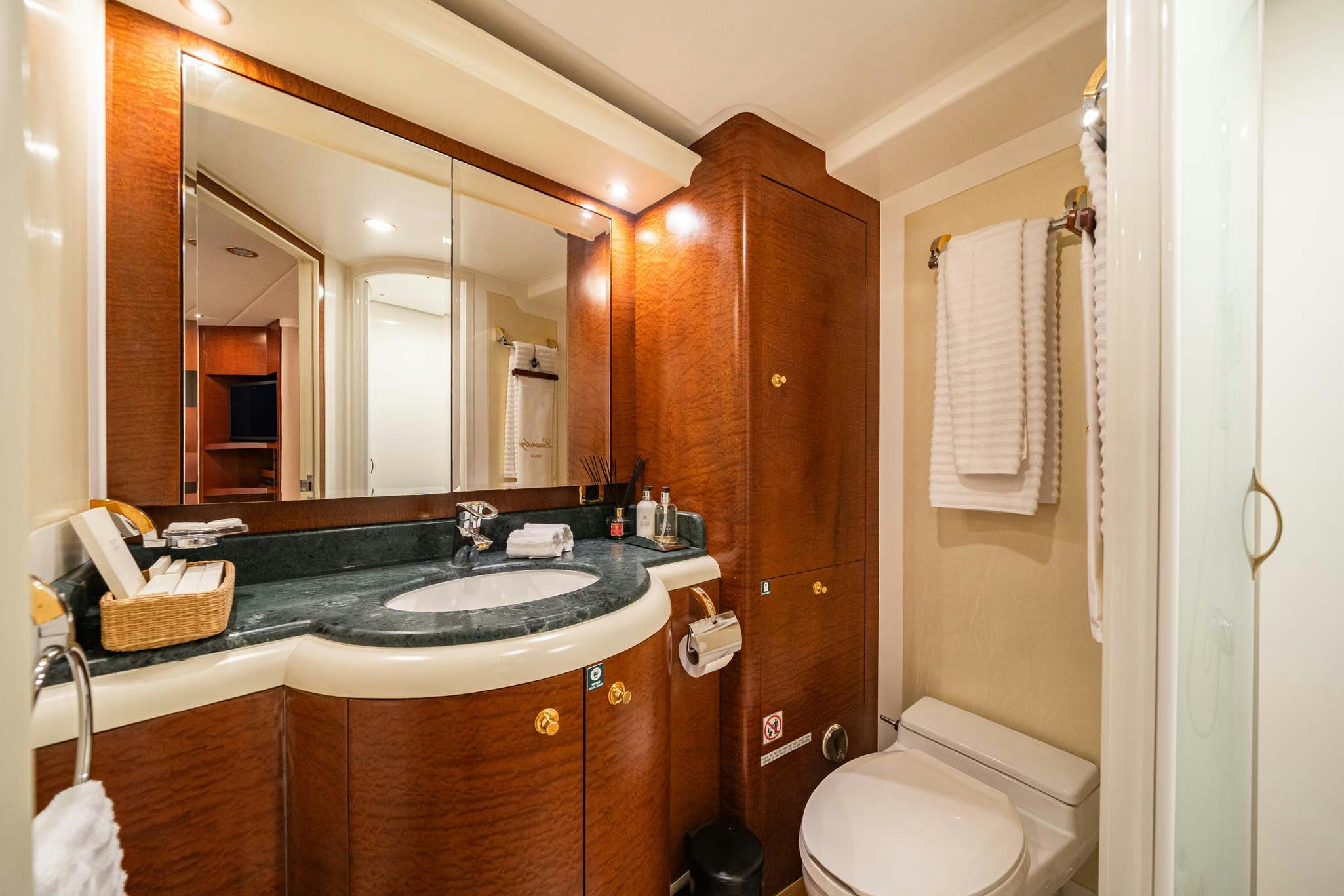a bathroom with a sink and a mirror aboard VIKING III Yacht for Charter