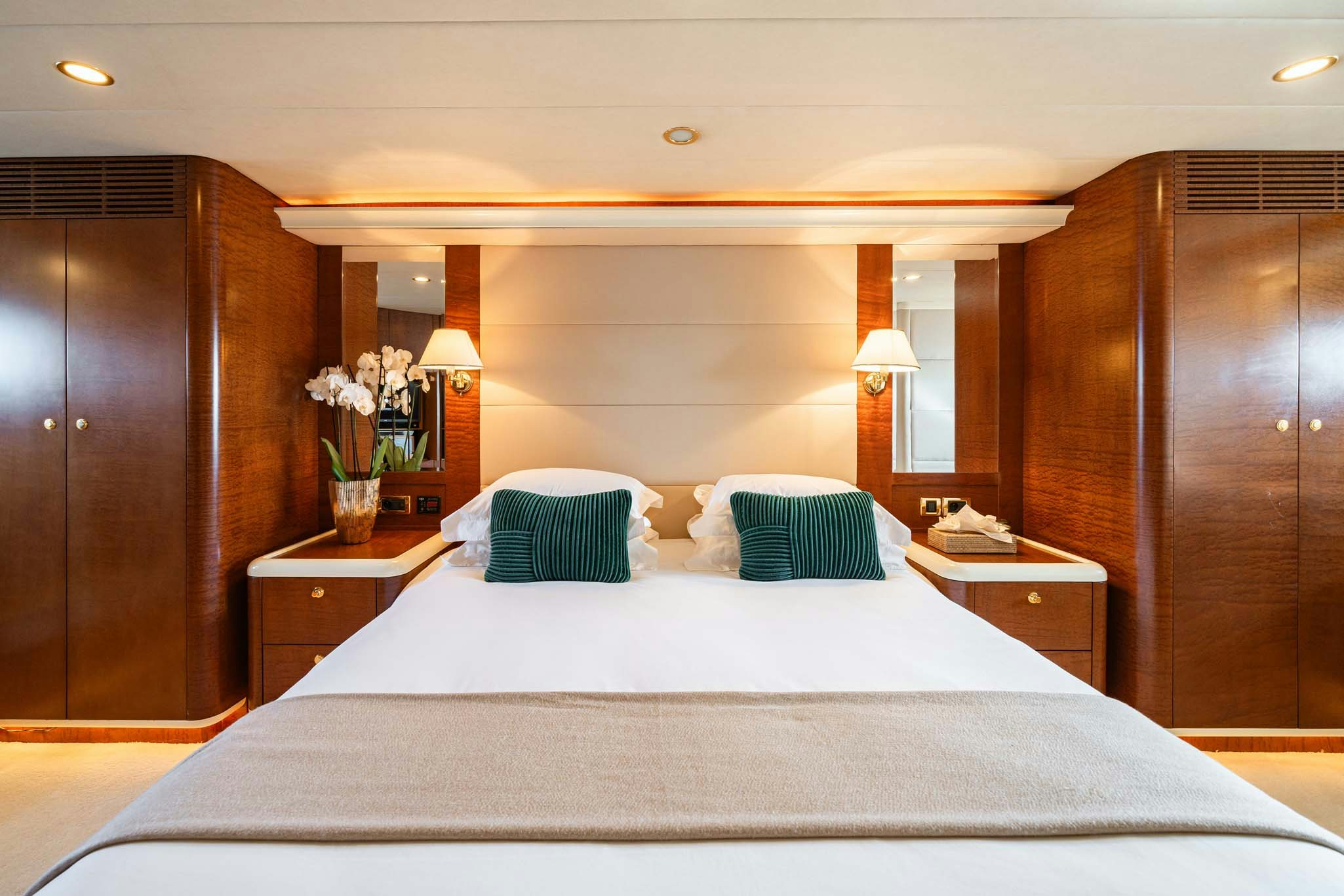 a bed with a white comforter and pillows aboard VIKING III Yacht for Charter