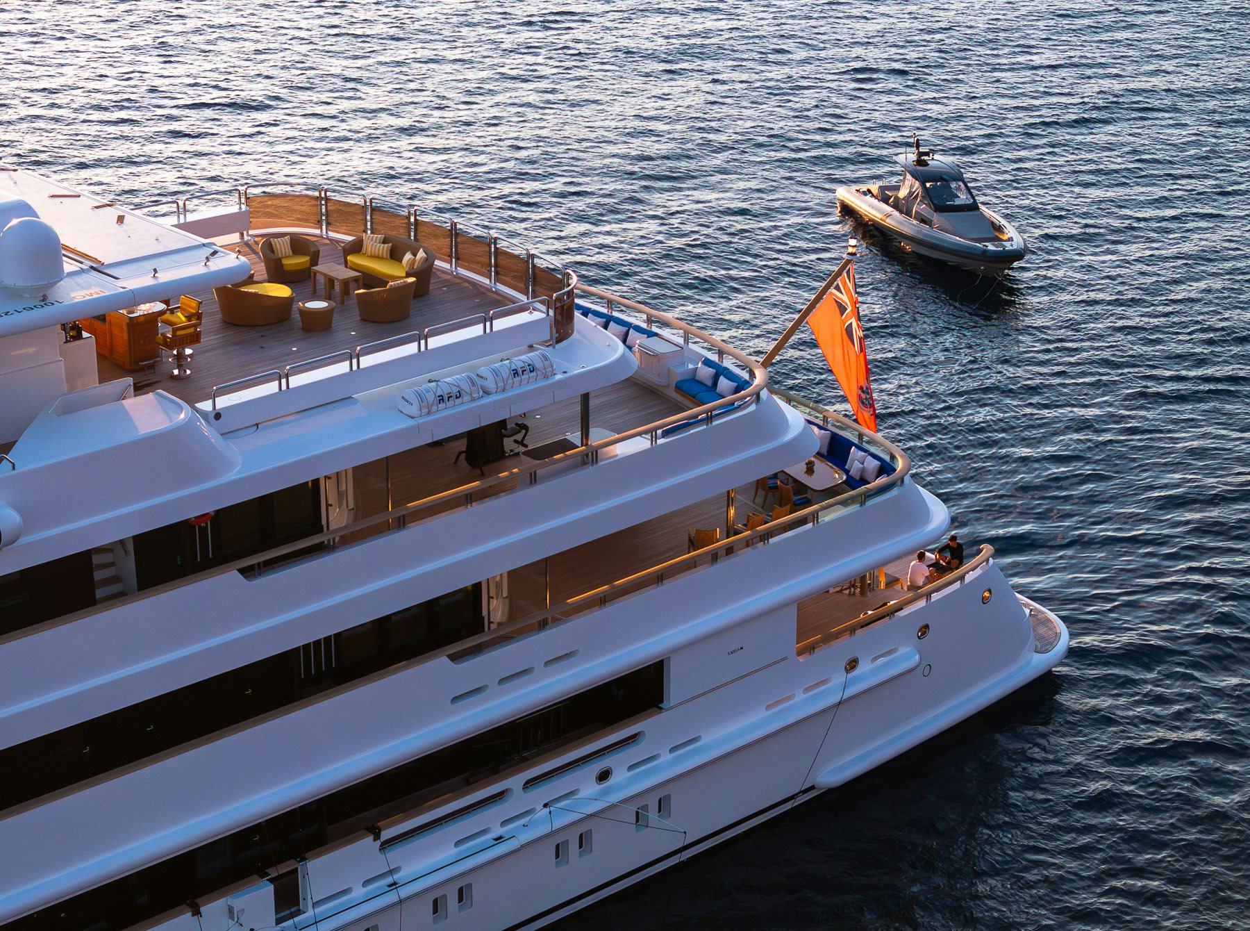 a large ship with a smaller boat on it aboard BOADICEA Yacht for Charter