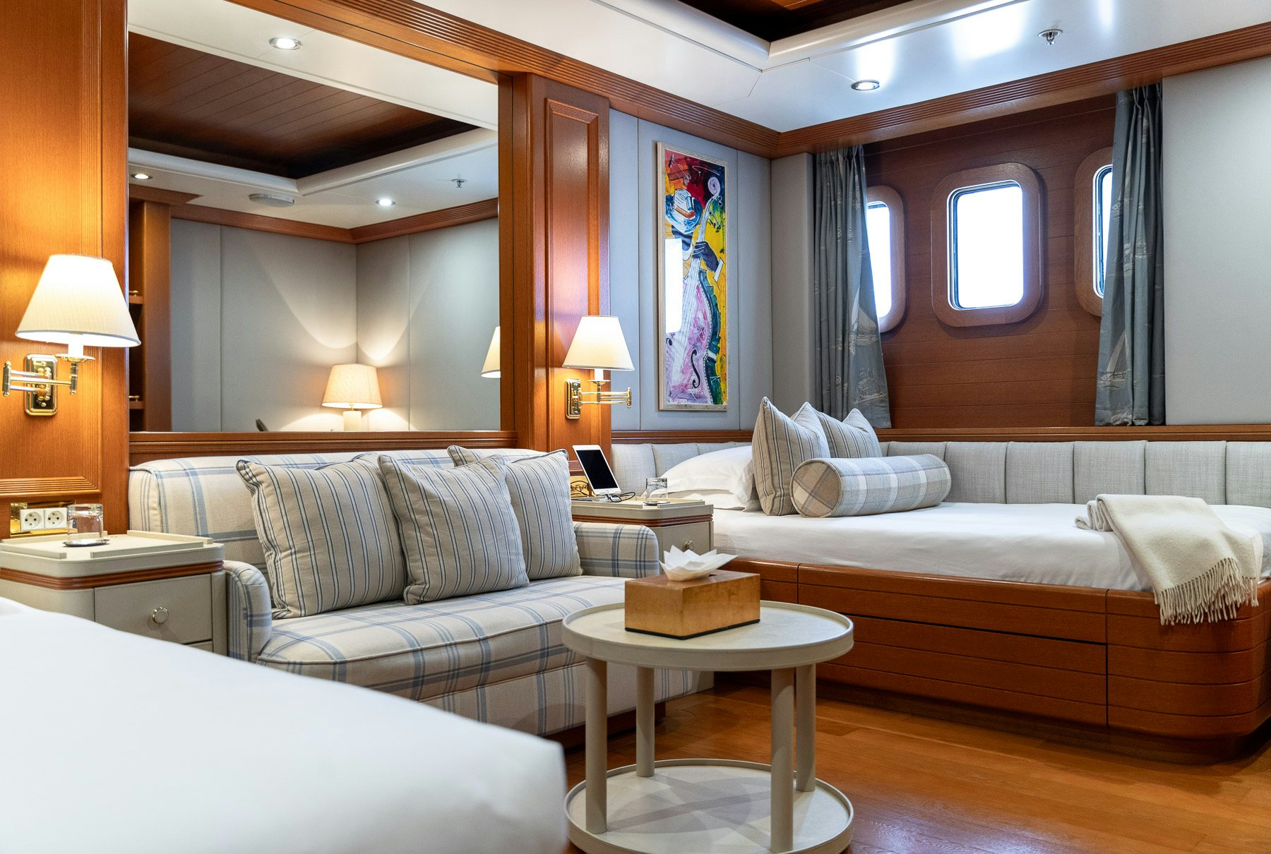 a room with a bed and a couch aboard BOADICEA Yacht for Charter