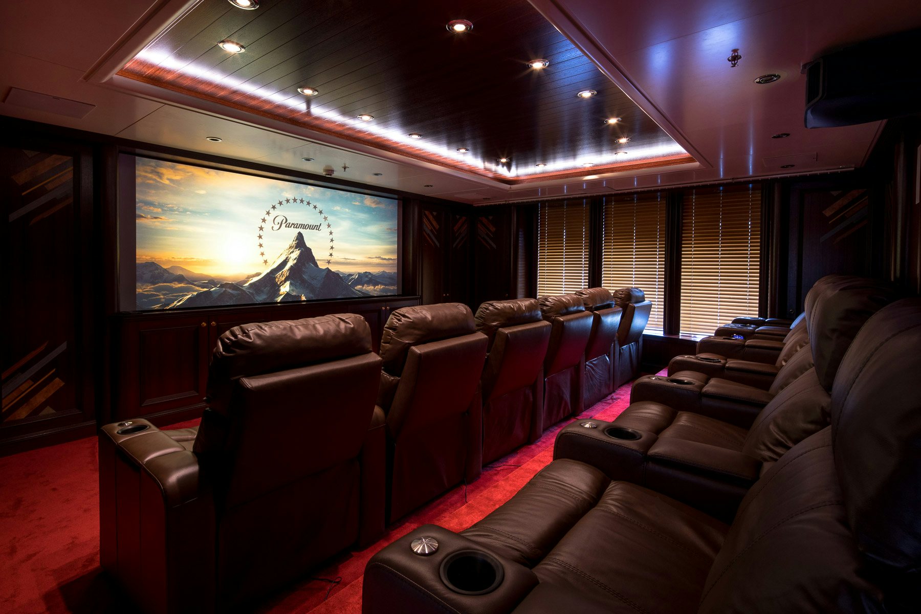 a room with leather couches and a large screen aboard BOADICEA Yacht for Charter