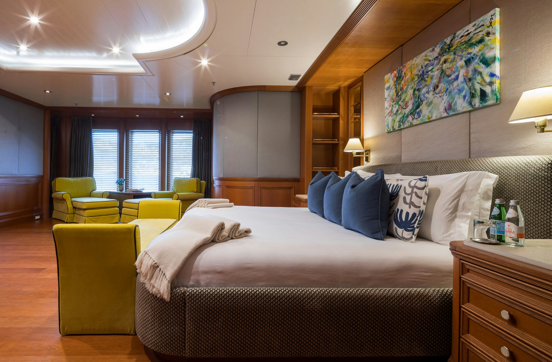 a bedroom with a bed and a table aboard BOADICEA Yacht for Charter
