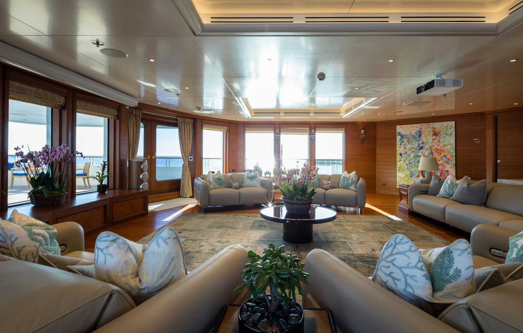 a living room with a large window aboard BOADICEA Yacht for Charter