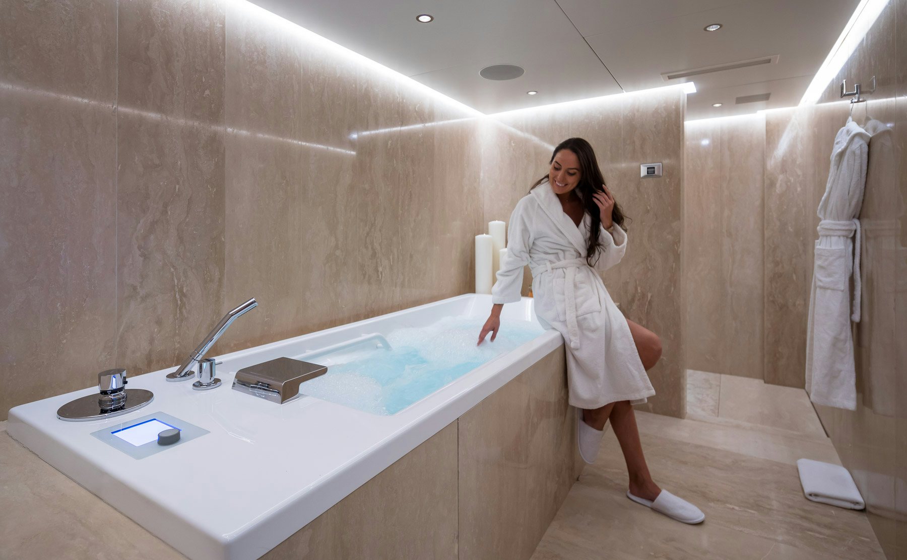 a person in a white dress in a bathroom aboard BOADICEA Yacht for Charter