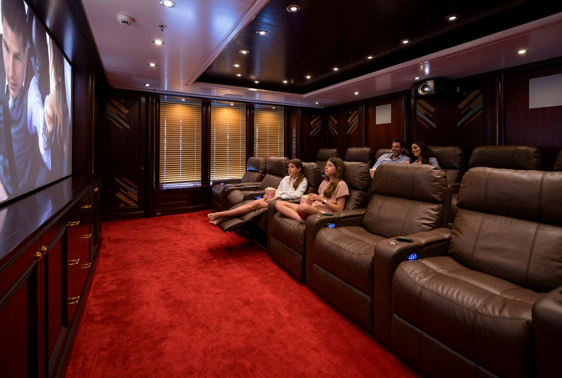 people sitting on couches in a room aboard BOADICEA Yacht for Charter