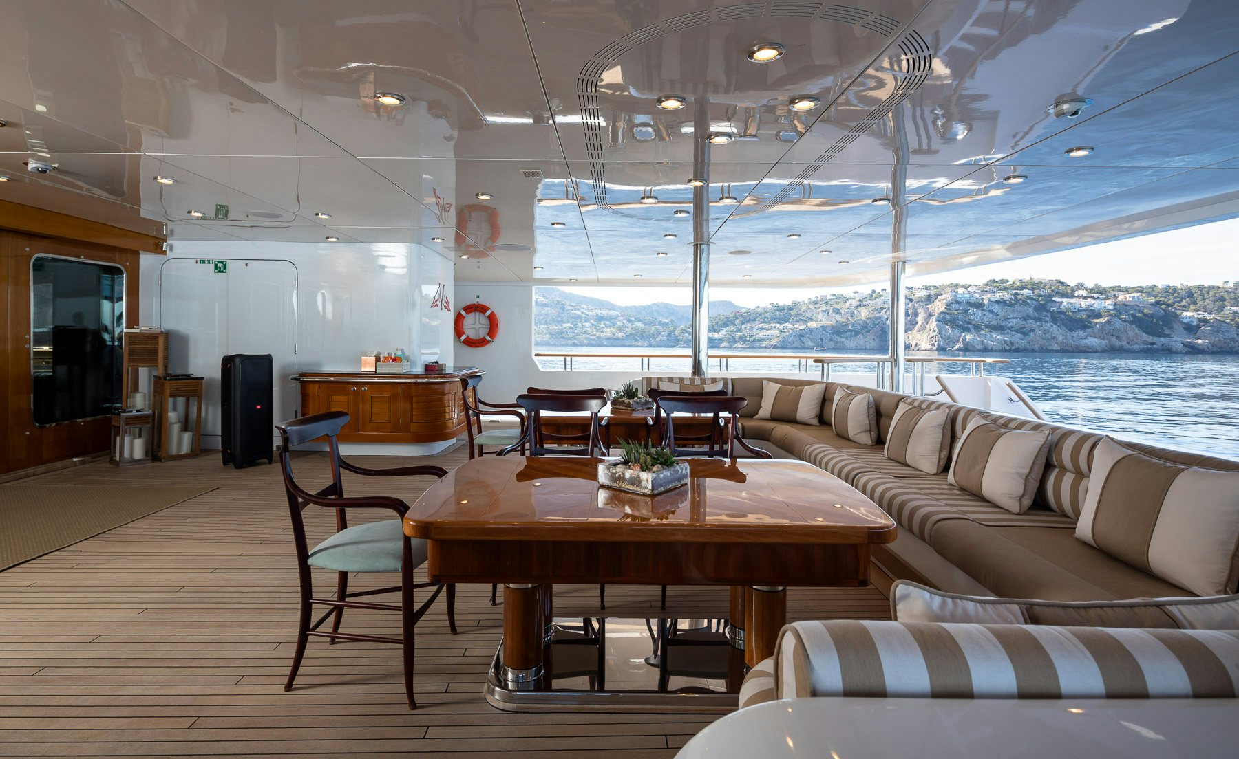a room with a couch and a table and a tv aboard BOADICEA Yacht for Charter