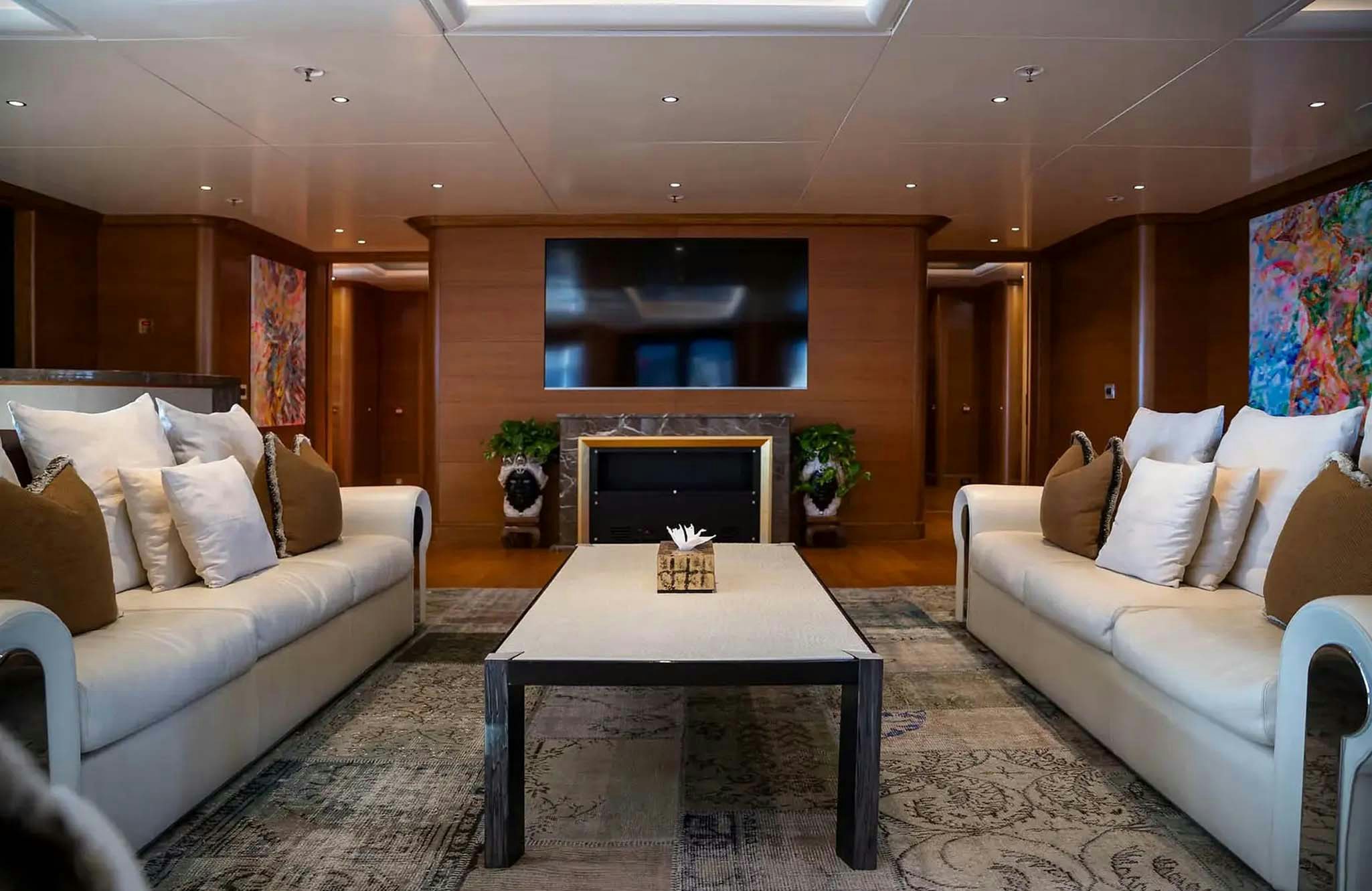 a living room with a fireplace aboard BOADICEA Yacht for Charter
