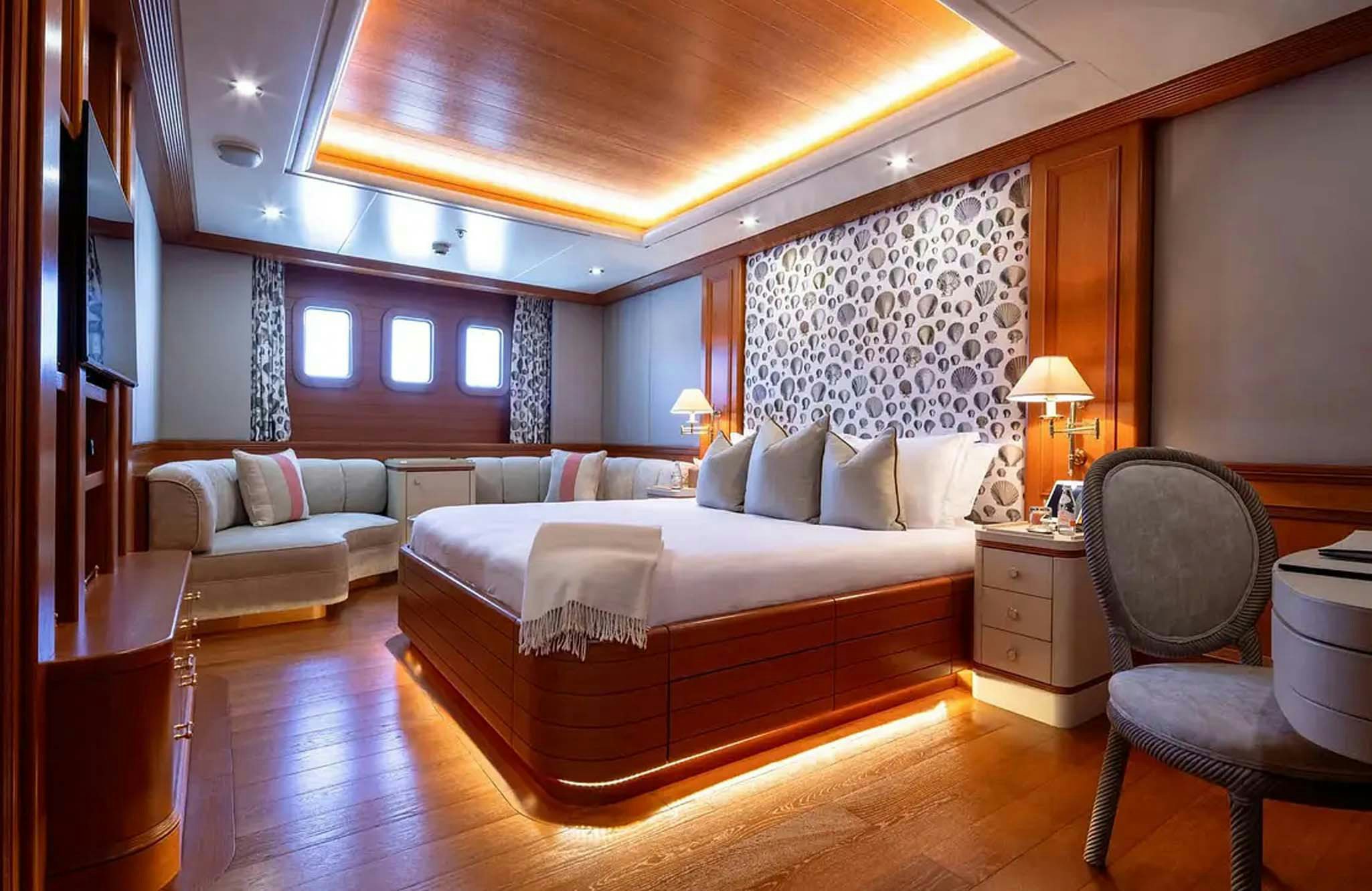 a large bedroom with a bed and a couch aboard BOADICEA Yacht for Charter