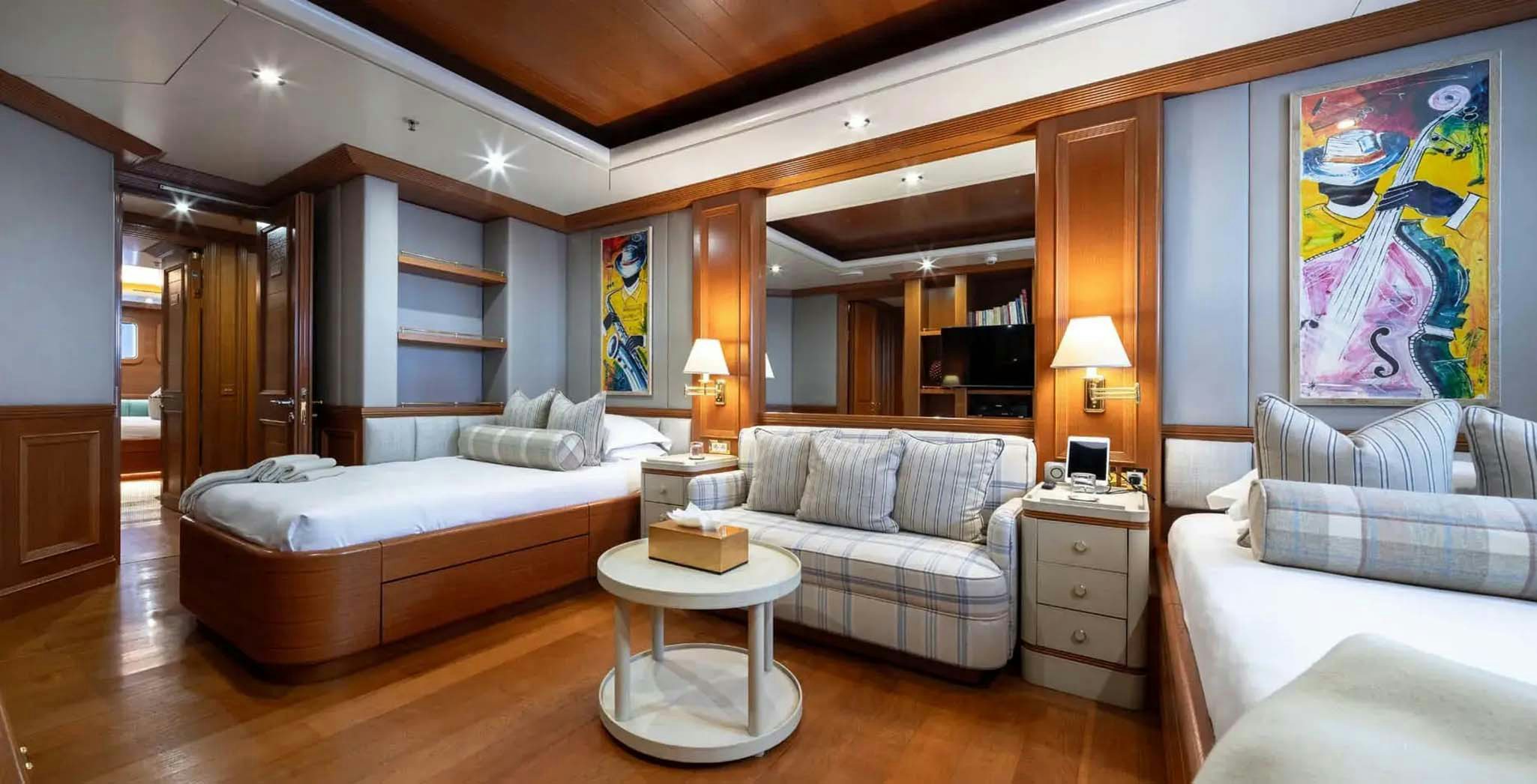 a living room with a bed and a couch aboard BOADICEA Yacht for Charter
