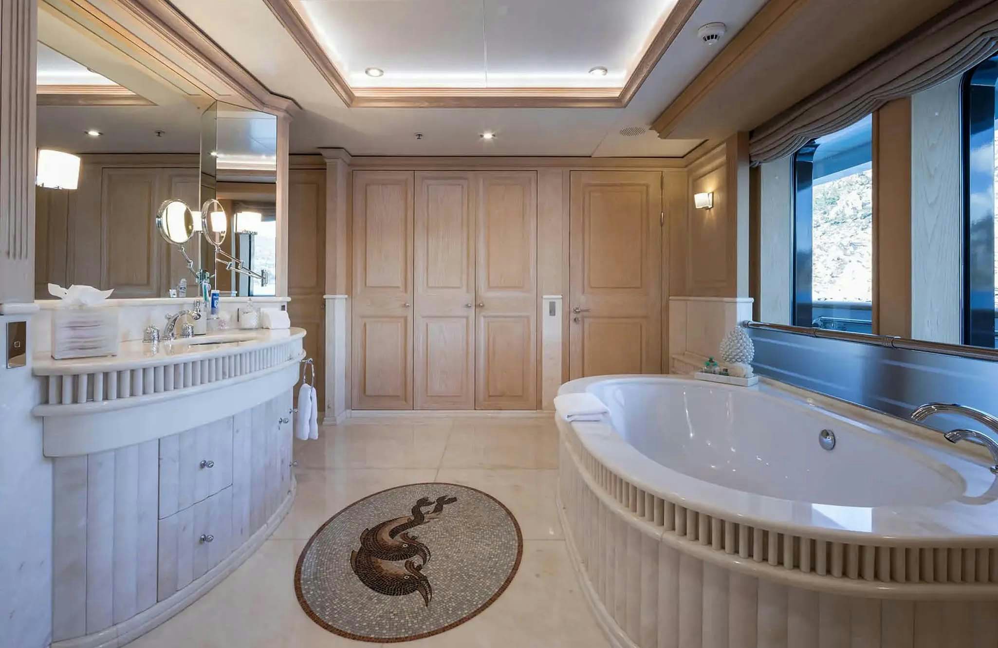 a bathroom with a tub sink and a sink aboard BOADICEA Yacht for Charter