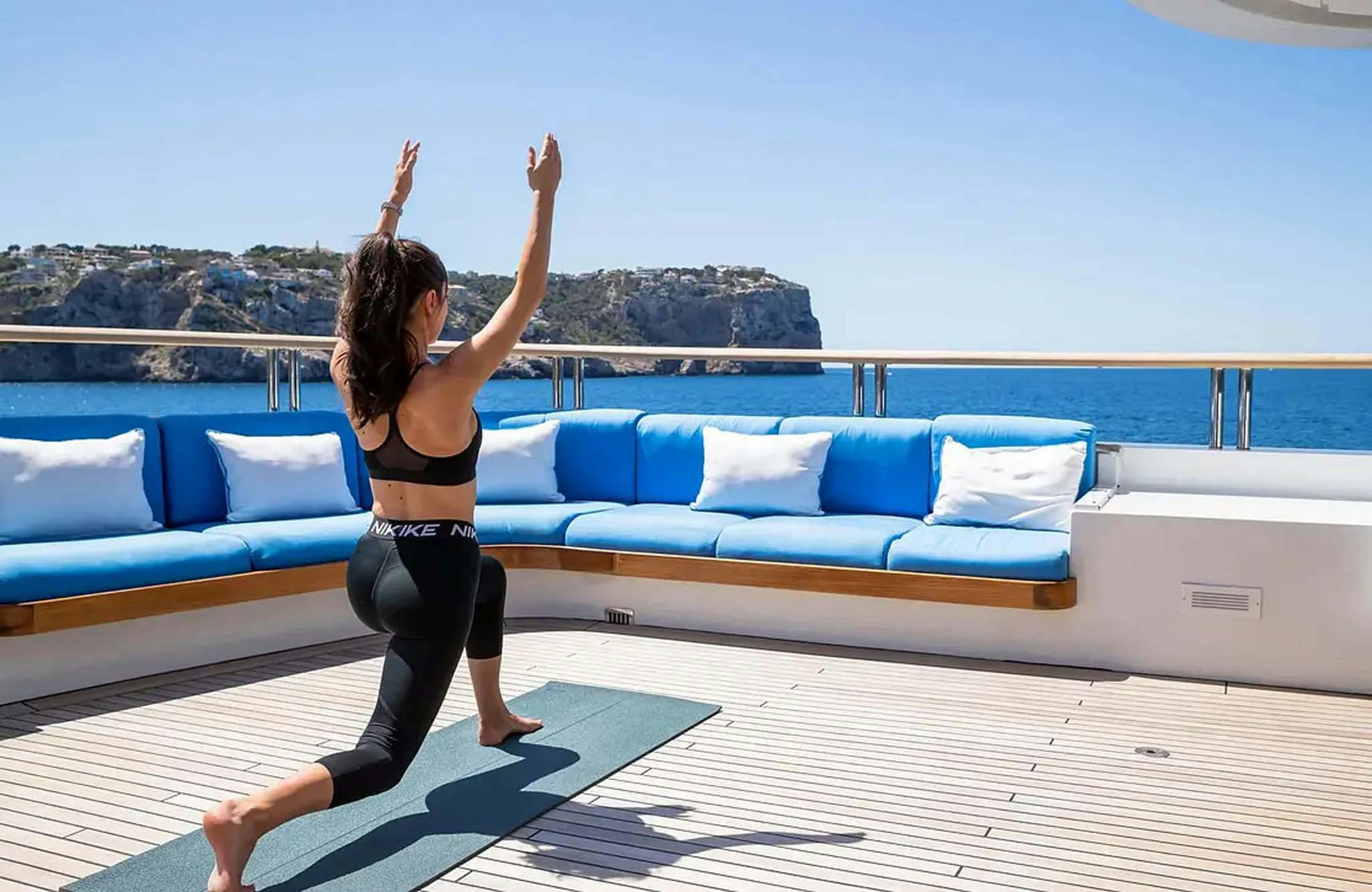 a woman jumping in the air aboard BOADICEA Yacht for Charter