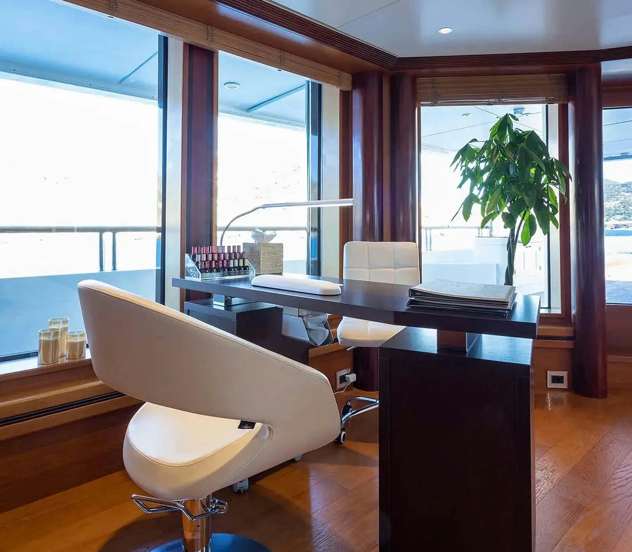 a room with a desk and chairs aboard BOADICEA Yacht for Charter