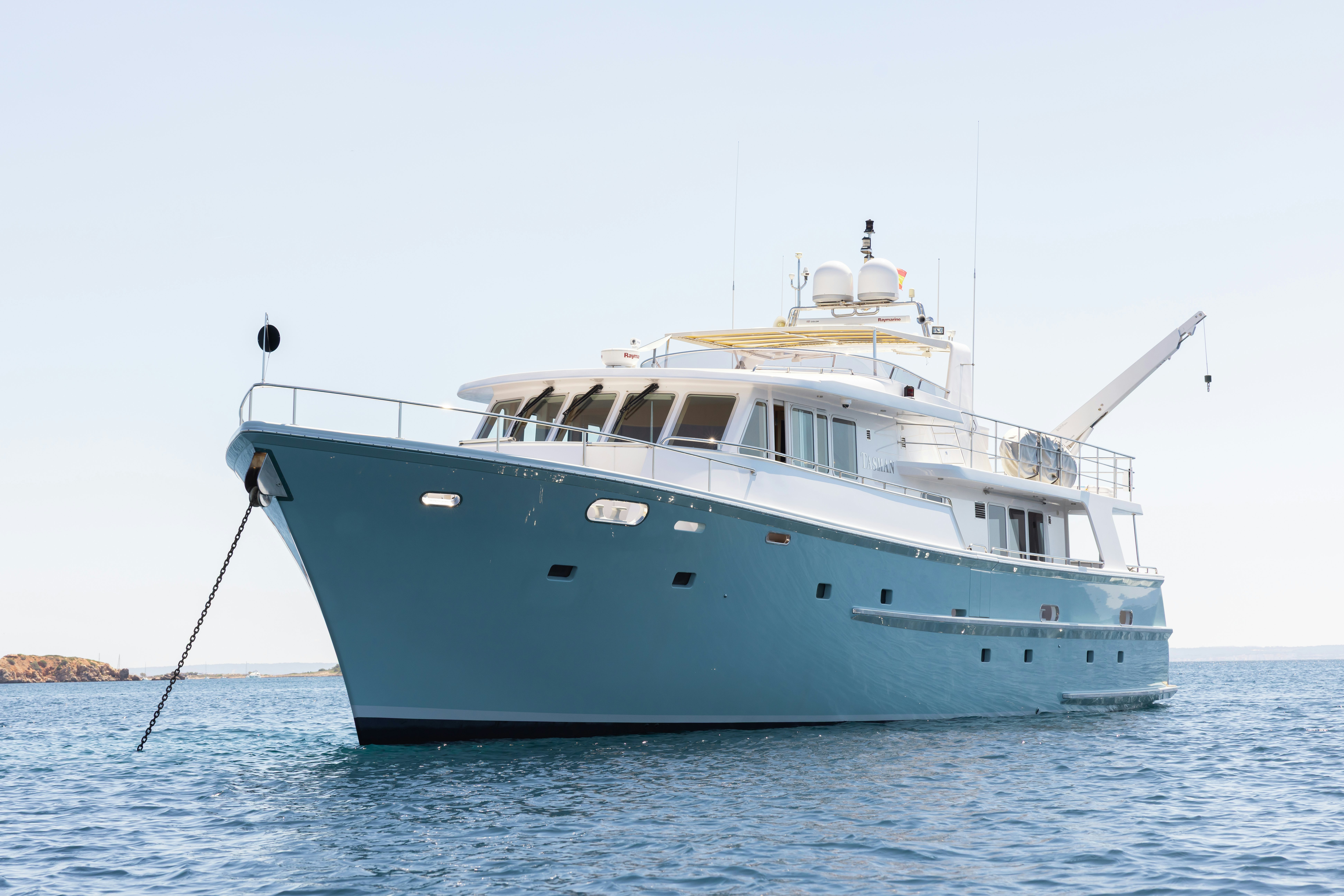 a large white boat in the water aboard TASMAN Yacht for Sale