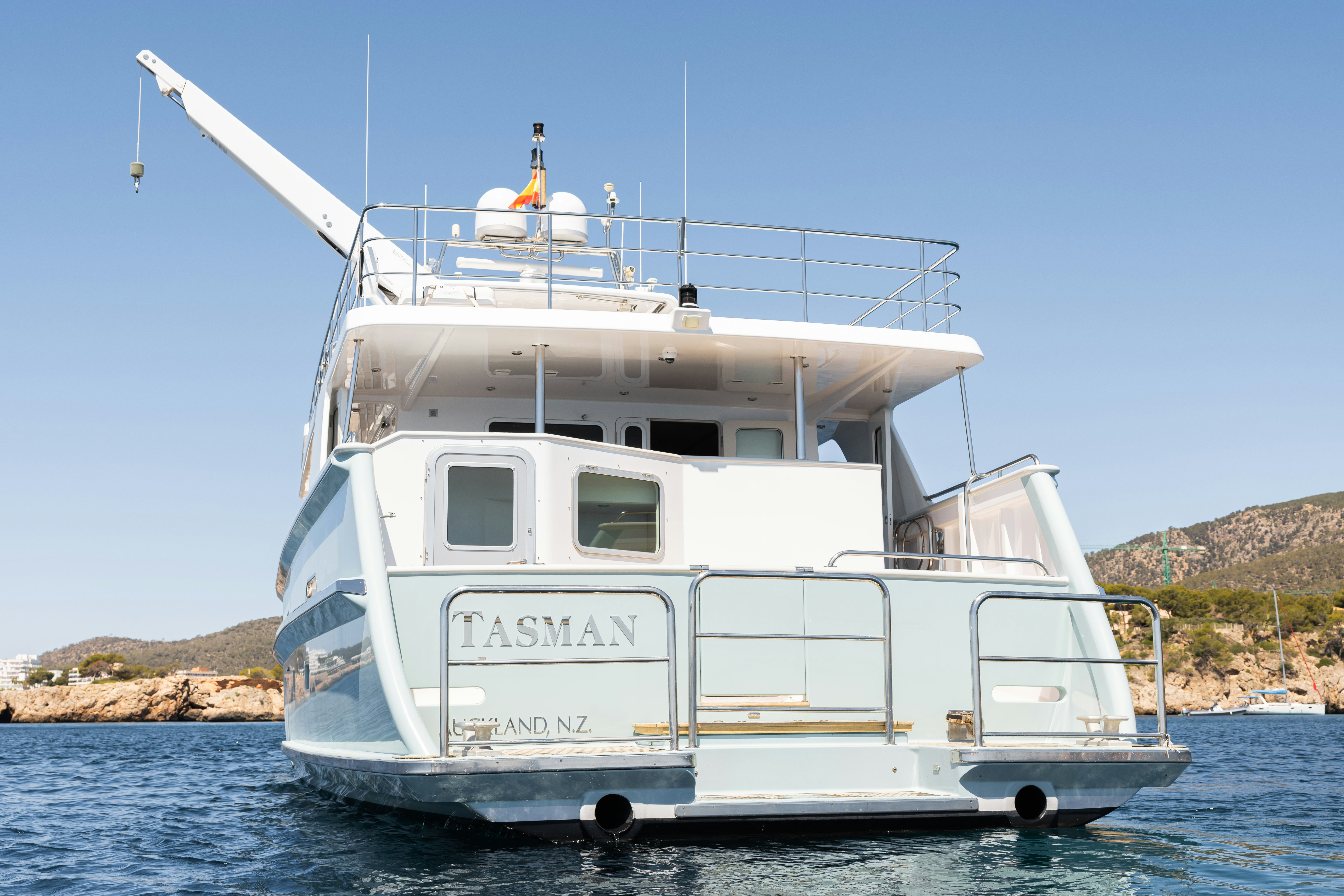 a white boat on water aboard TASMAN Yacht for Sale