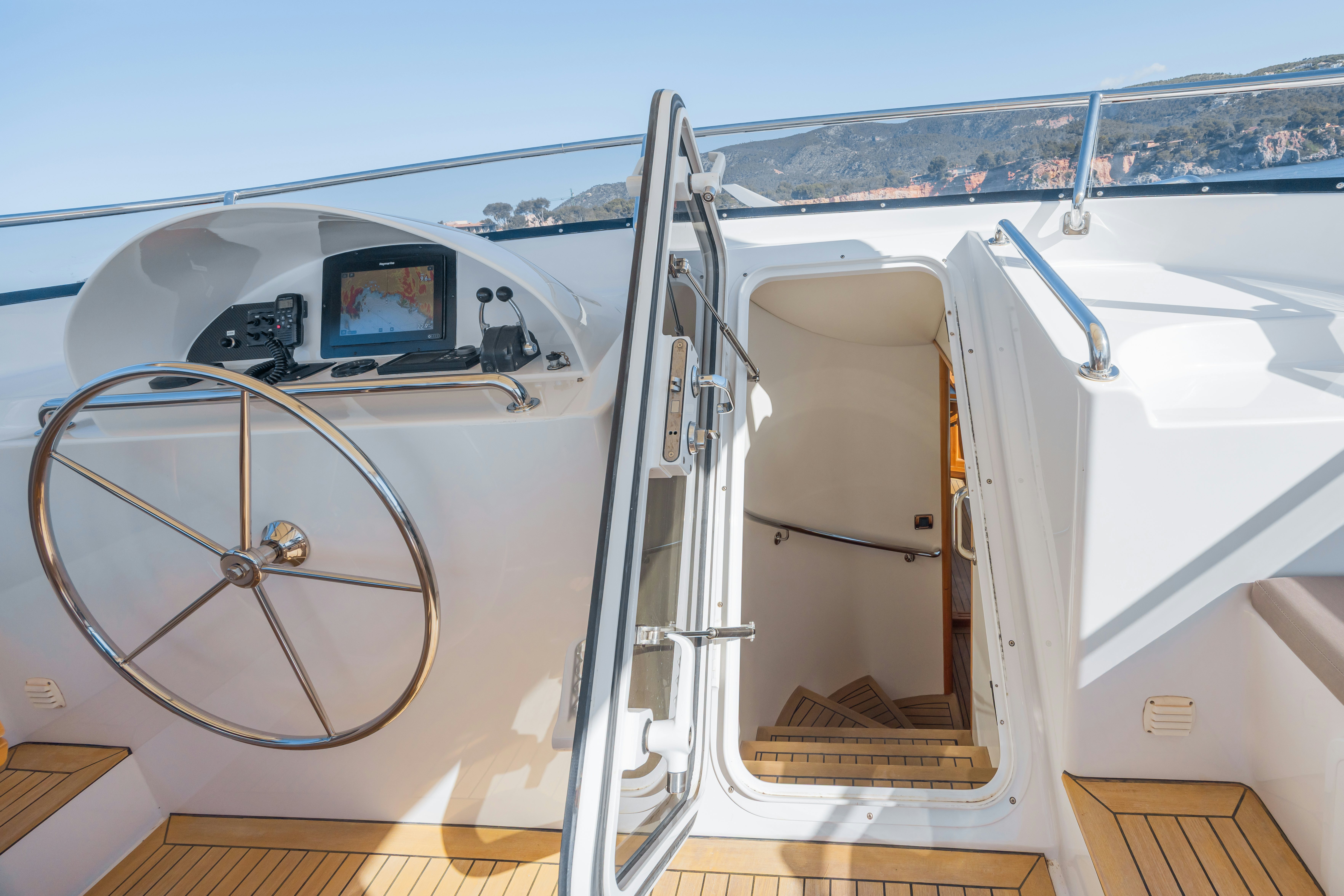 a white car with a large wheel aboard TASMAN Yacht for Sale