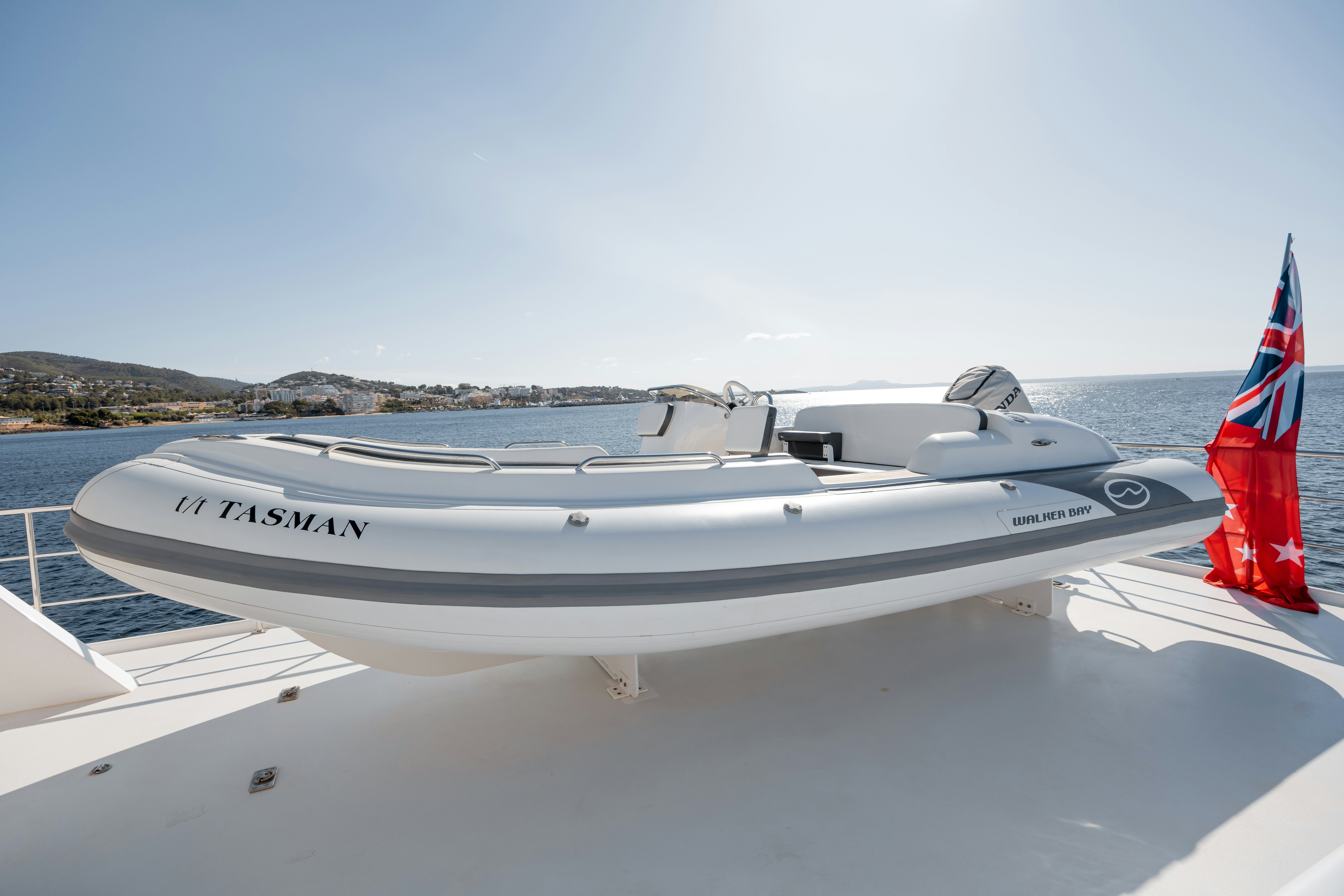 a white boat on a body of water aboard TASMAN Yacht for Sale