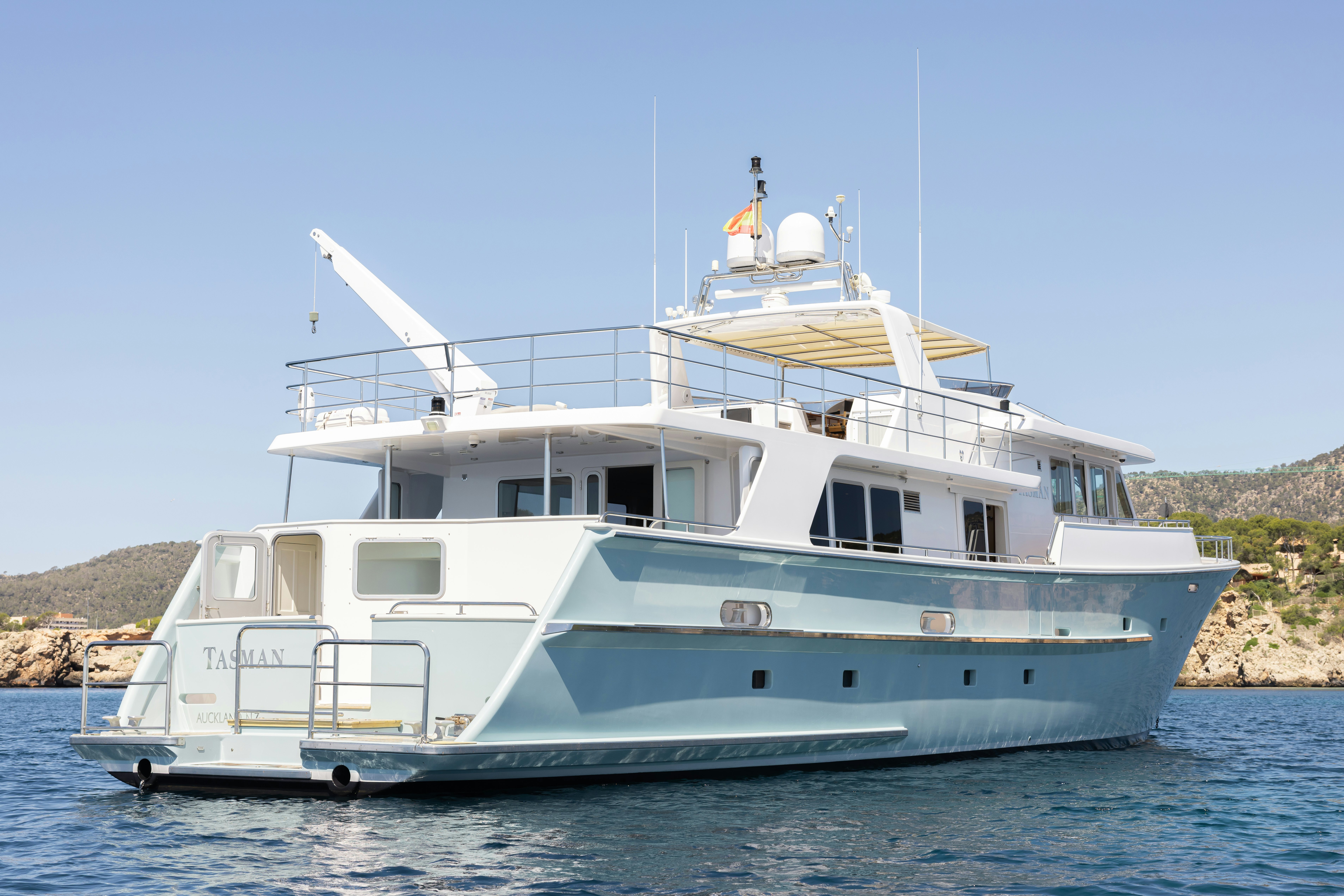 a white boat on the water aboard TASMAN Yacht for Sale