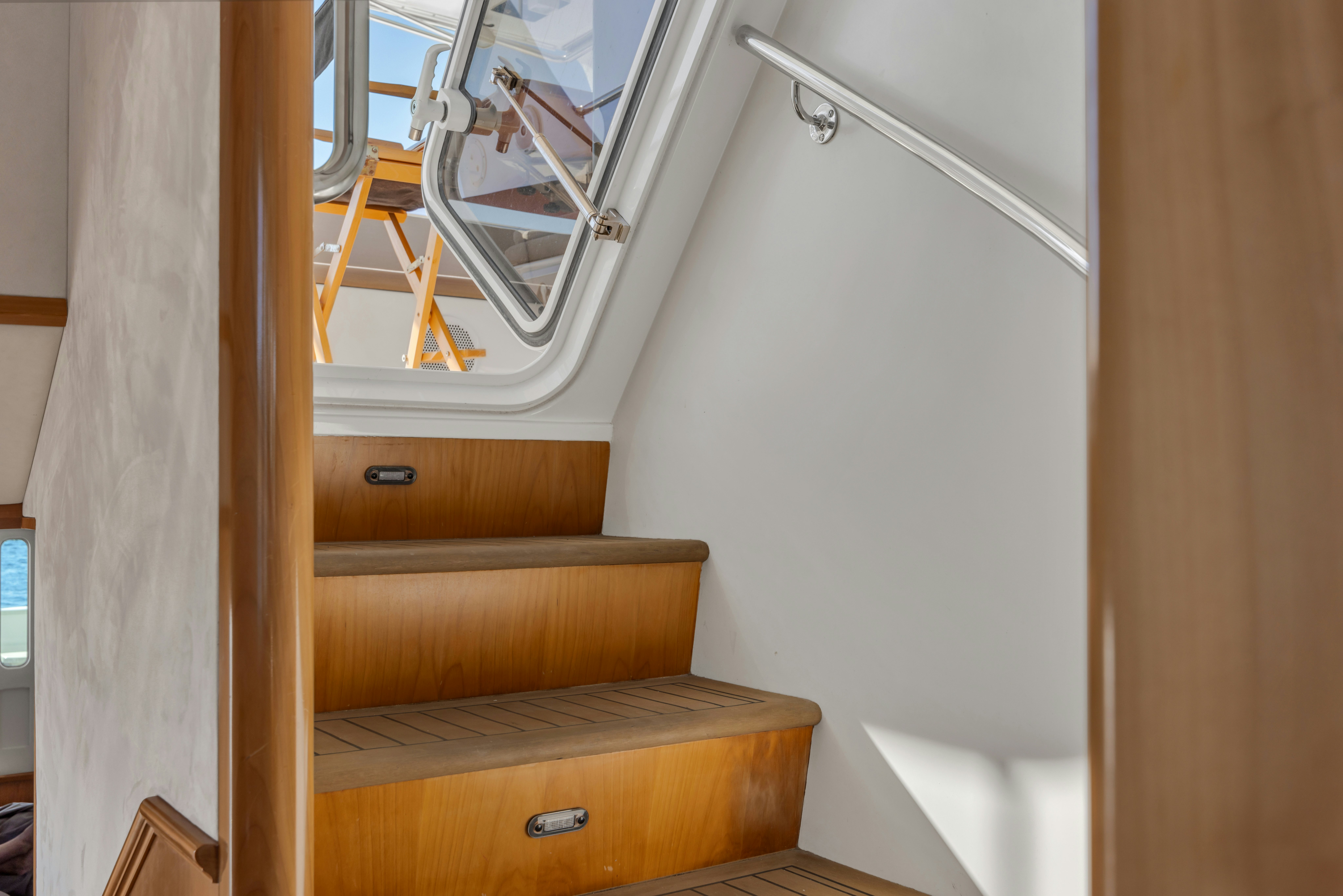 a wooden staircase with a mirror aboard TASMAN Yacht for Sale