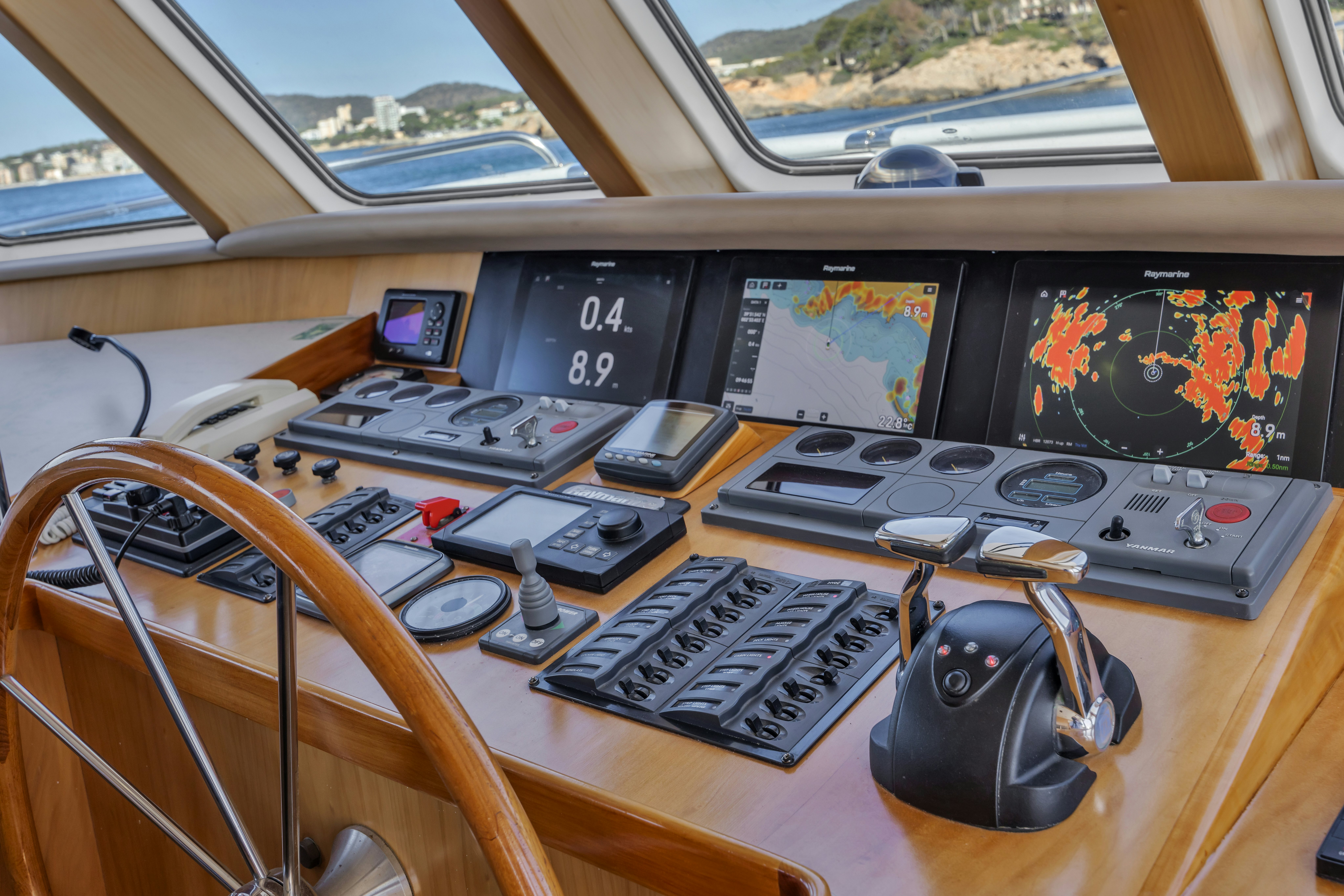 a table with electronic devices aboard TASMAN Yacht for Sale