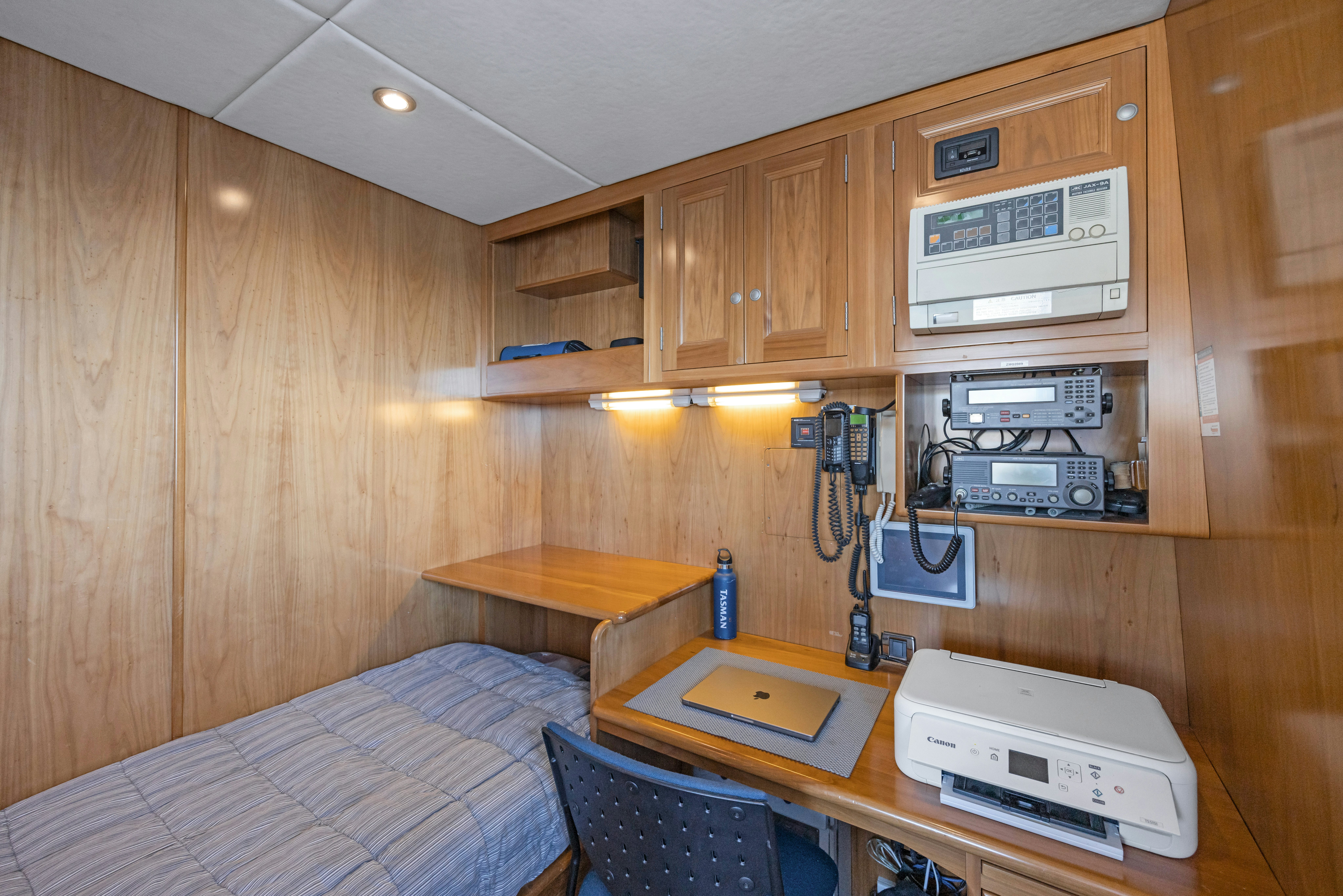 a room with a bed and a desk aboard TASMAN Yacht for Sale