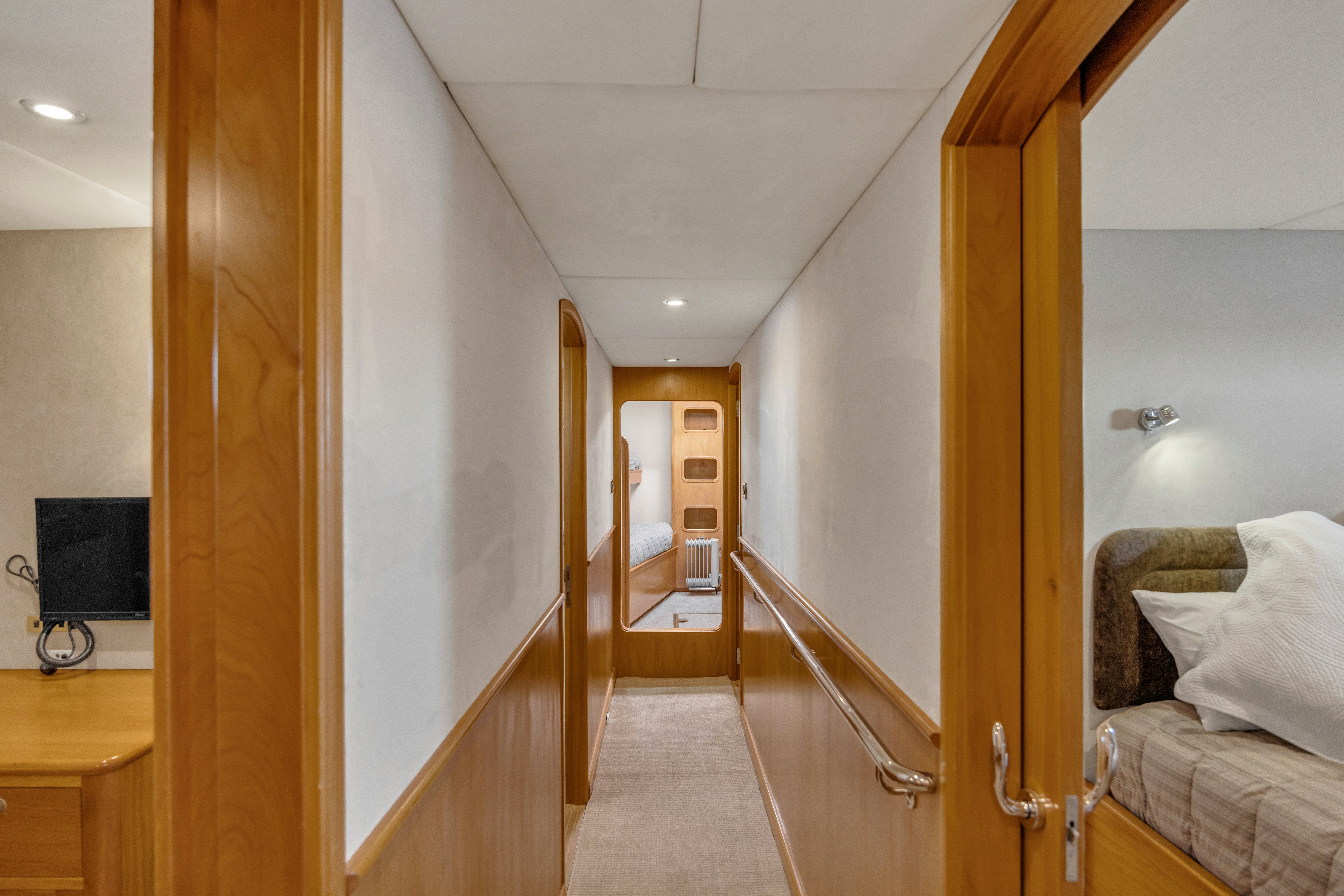 a room with a bed and a mirror aboard TASMAN Yacht for Sale