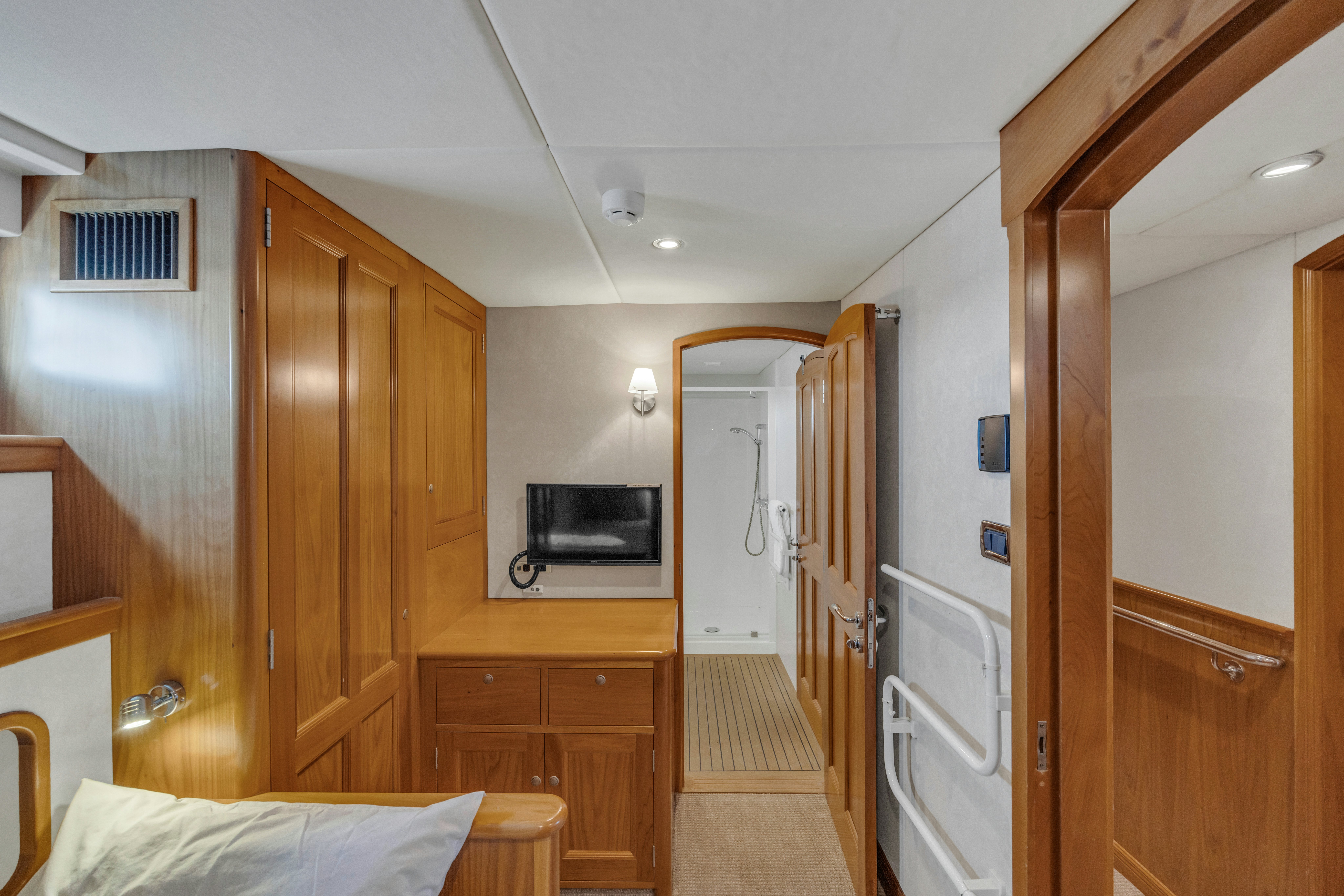 a room with wooden cabinets aboard TASMAN Yacht for Sale