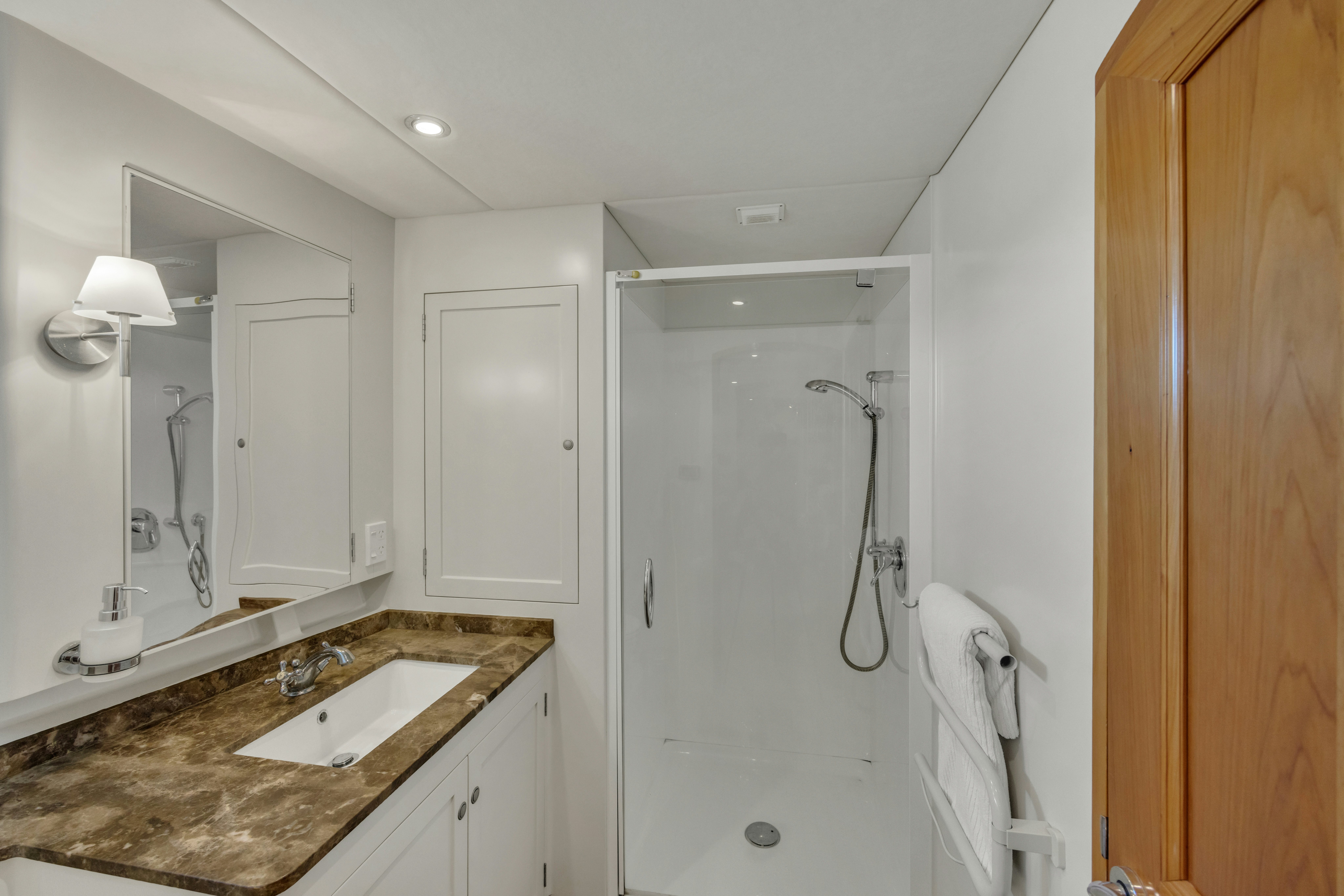 a bathroom with a sink and a mirror aboard TASMAN Yacht for Sale