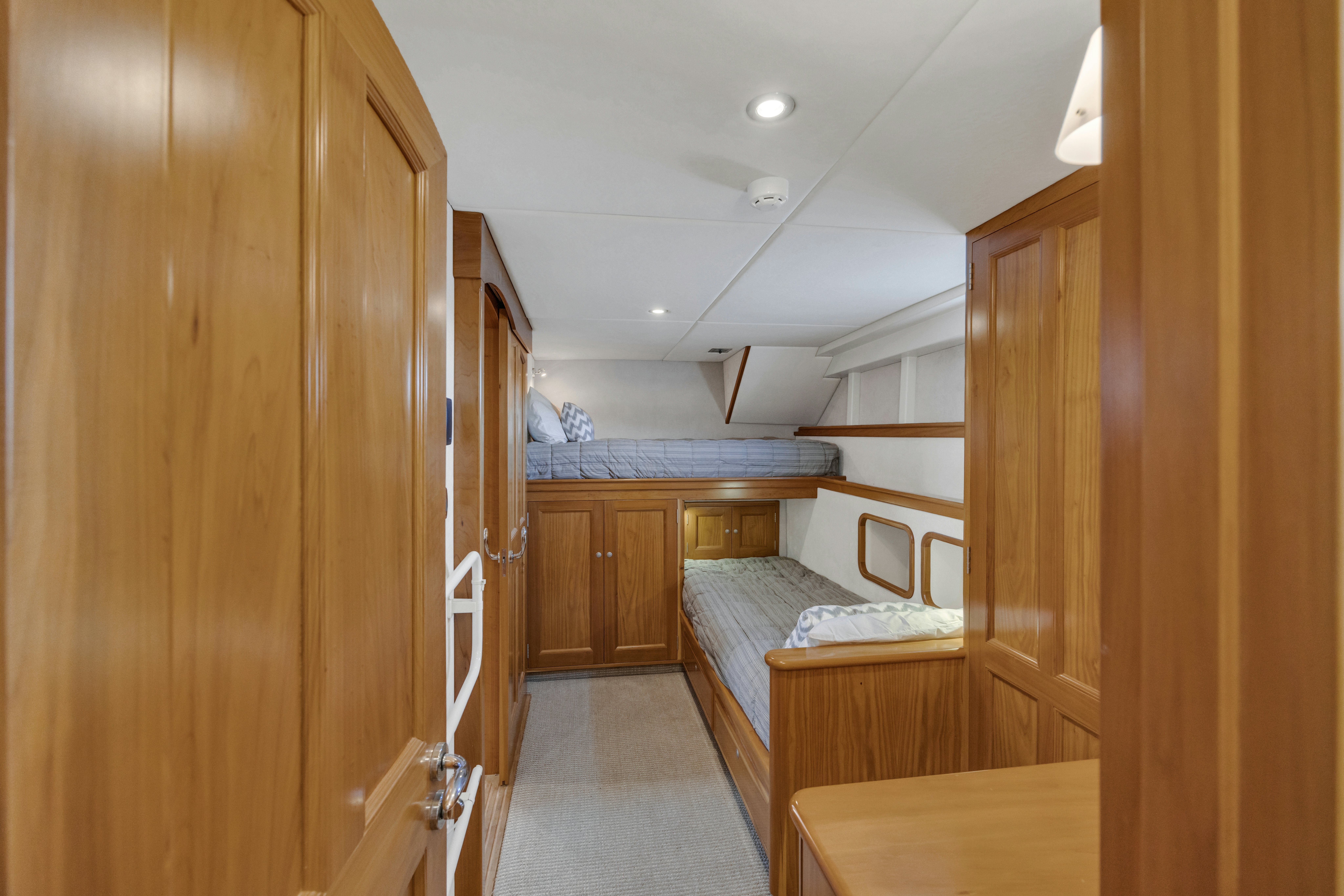 a room with wooden cabinets and a bed aboard TASMAN Yacht for Sale