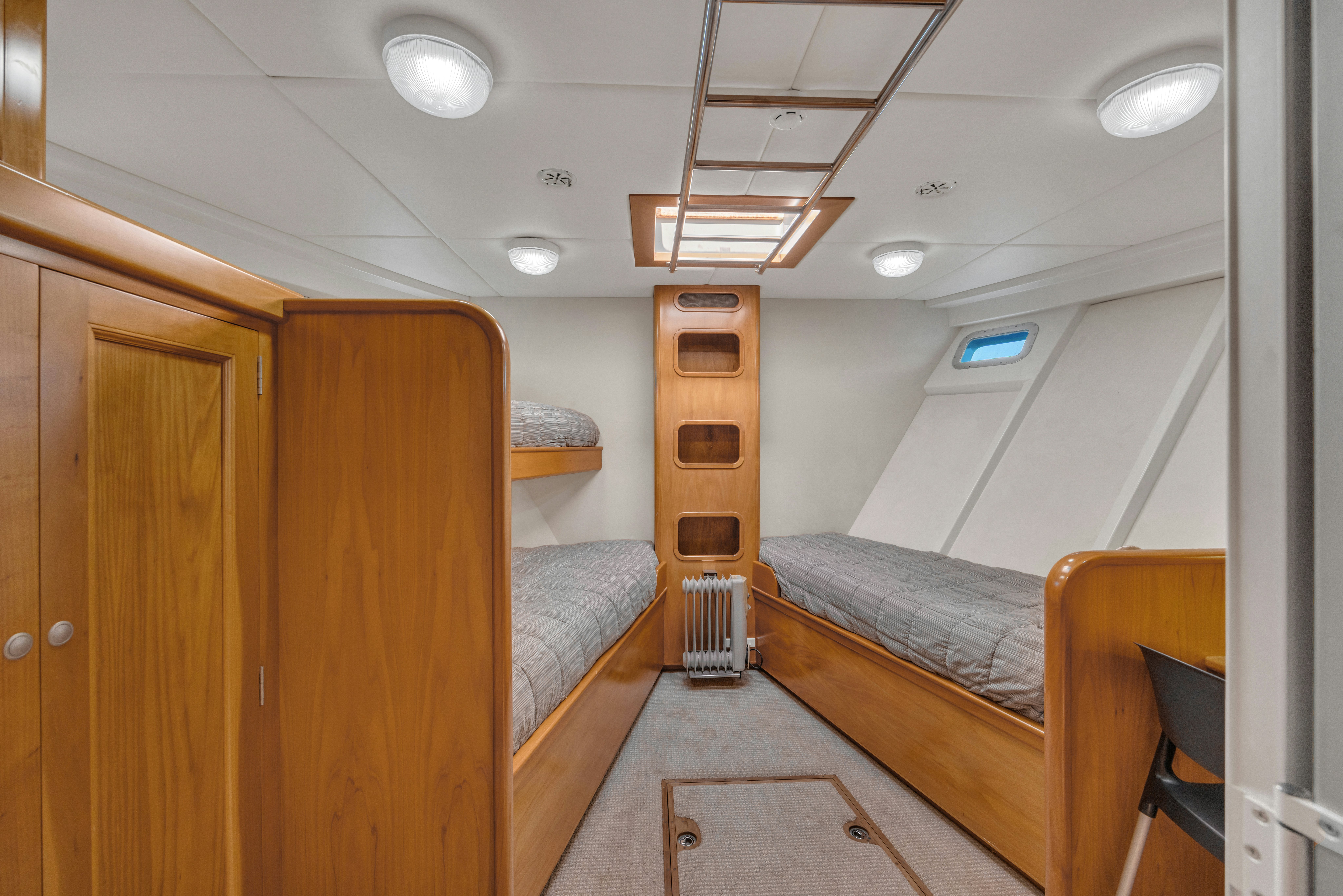a room with bunk beds aboard TASMAN Yacht for Sale