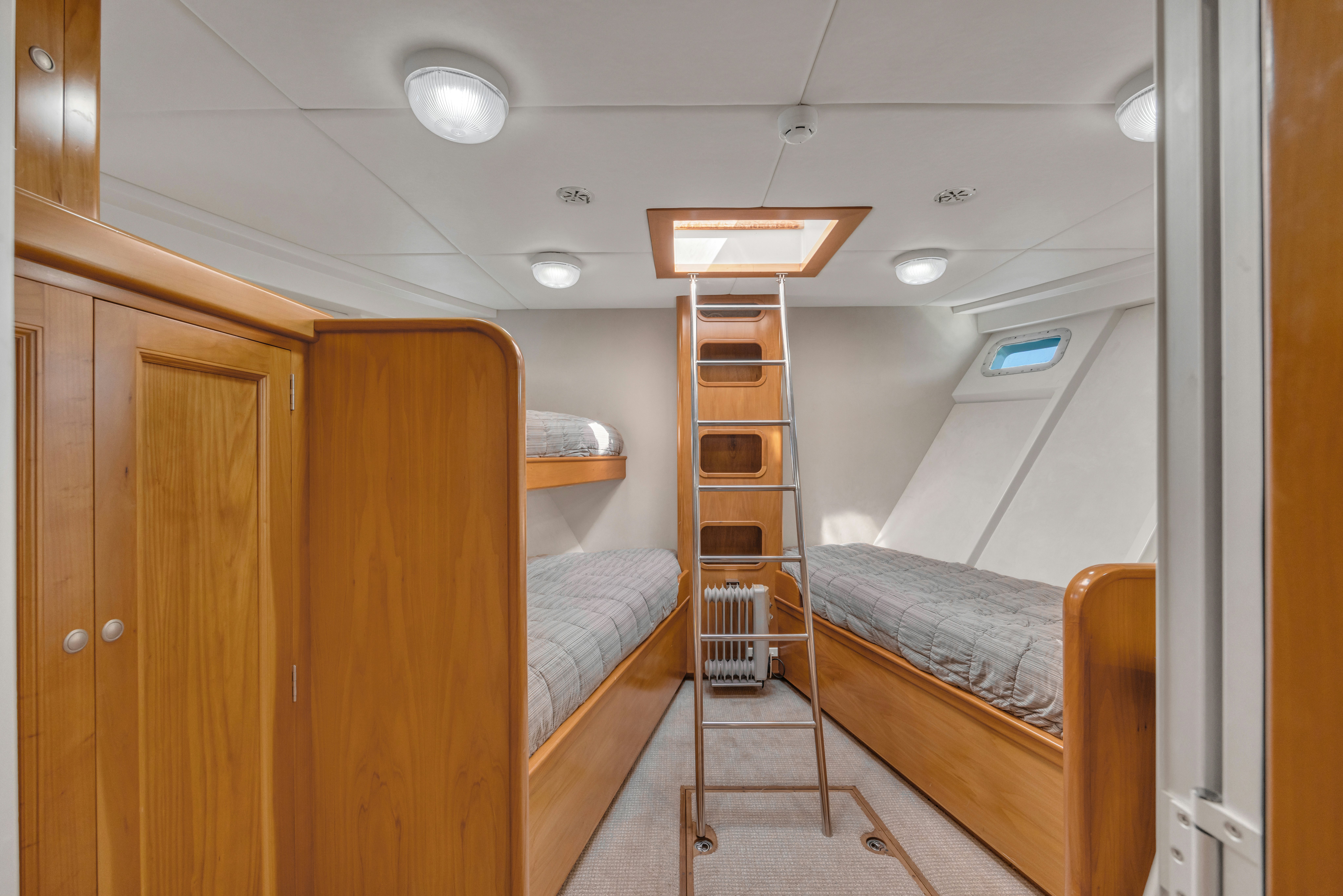 a room with bunk beds aboard TASMAN Yacht for Sale