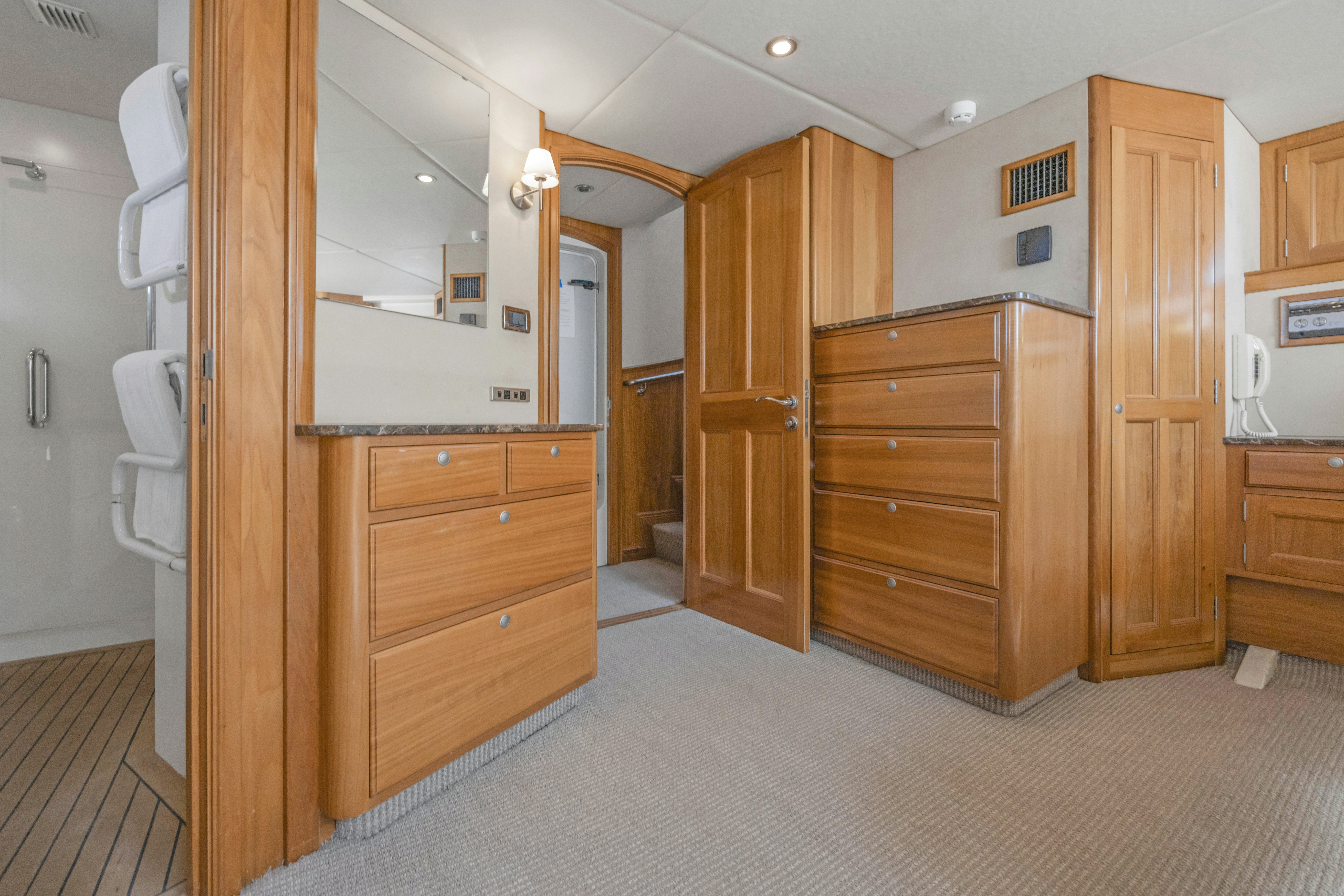 a room with wooden cabinets aboard TASMAN Yacht for Sale