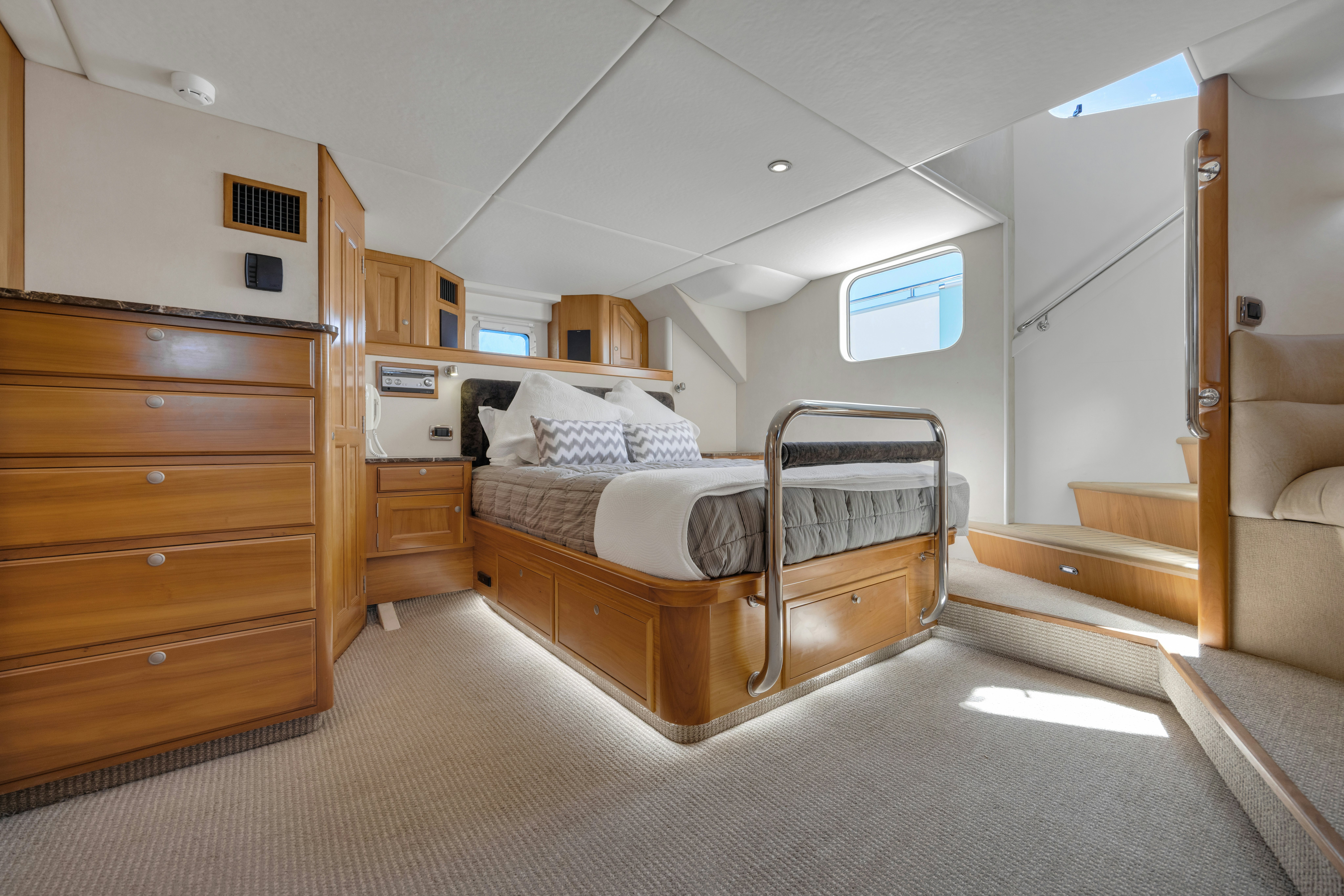 a bedroom with a bed and a desk aboard TASMAN Yacht for Sale