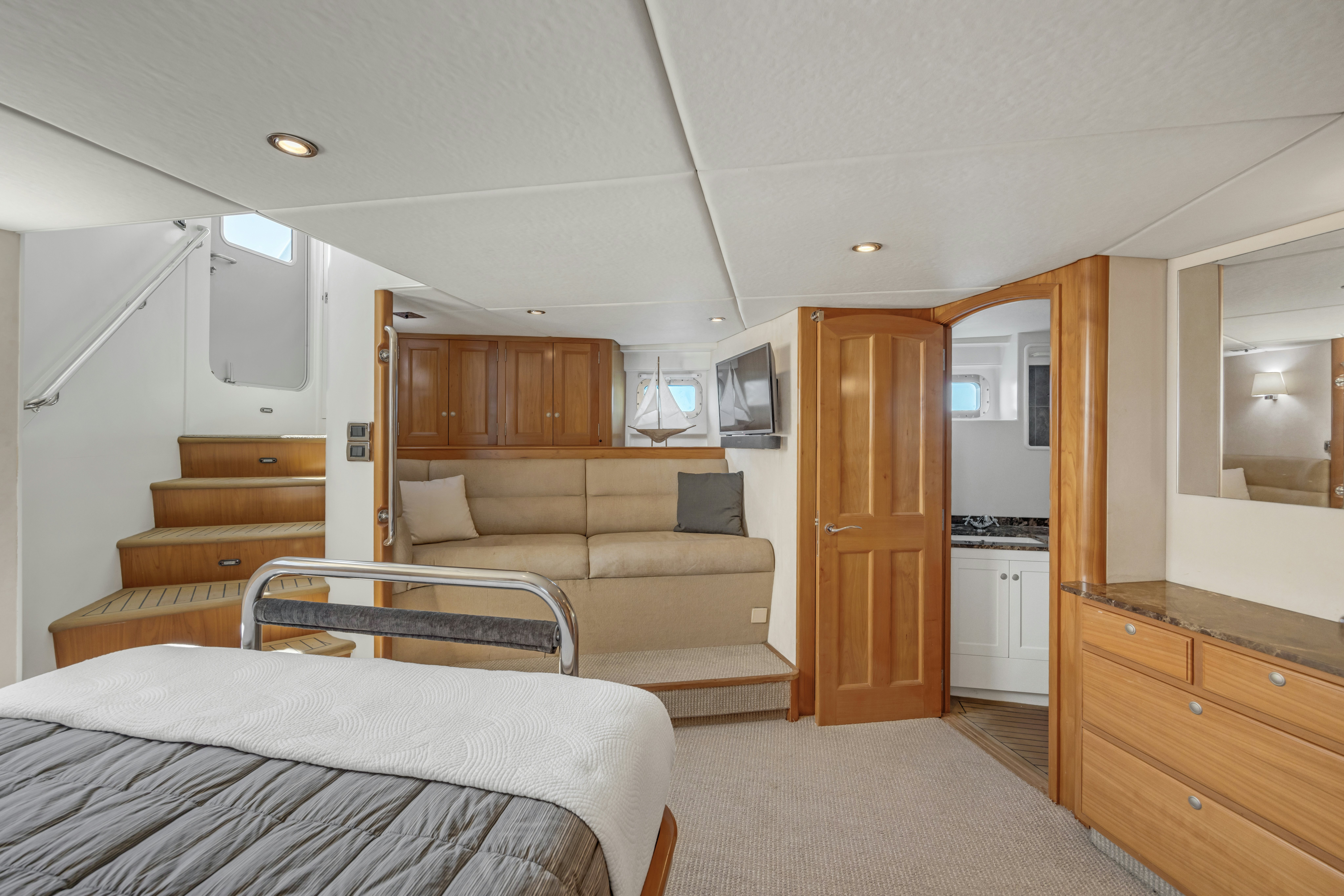 a bedroom with a bed and a couch aboard TASMAN Yacht for Sale