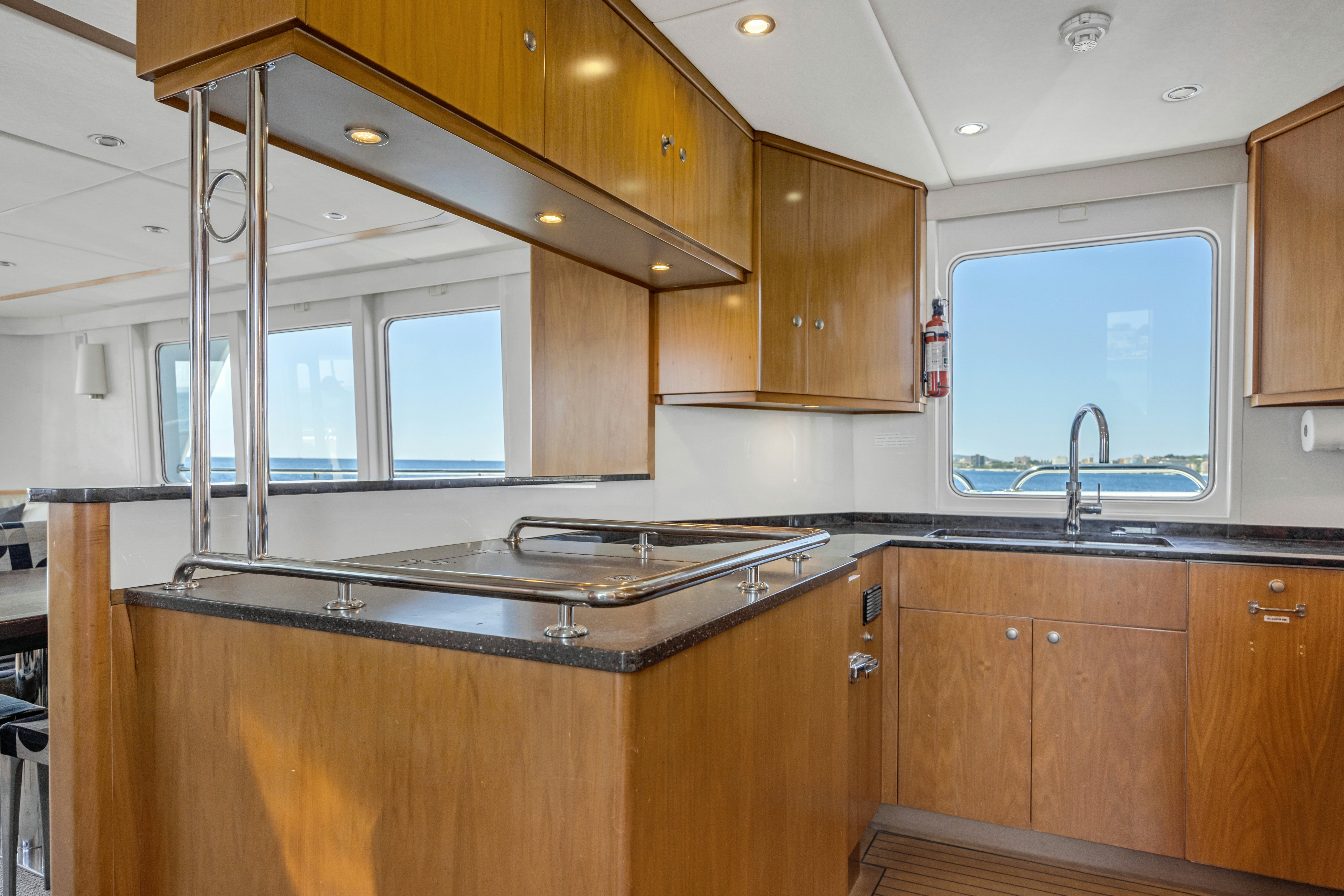 a kitchen with wooden cabinets aboard TASMAN Yacht for Sale