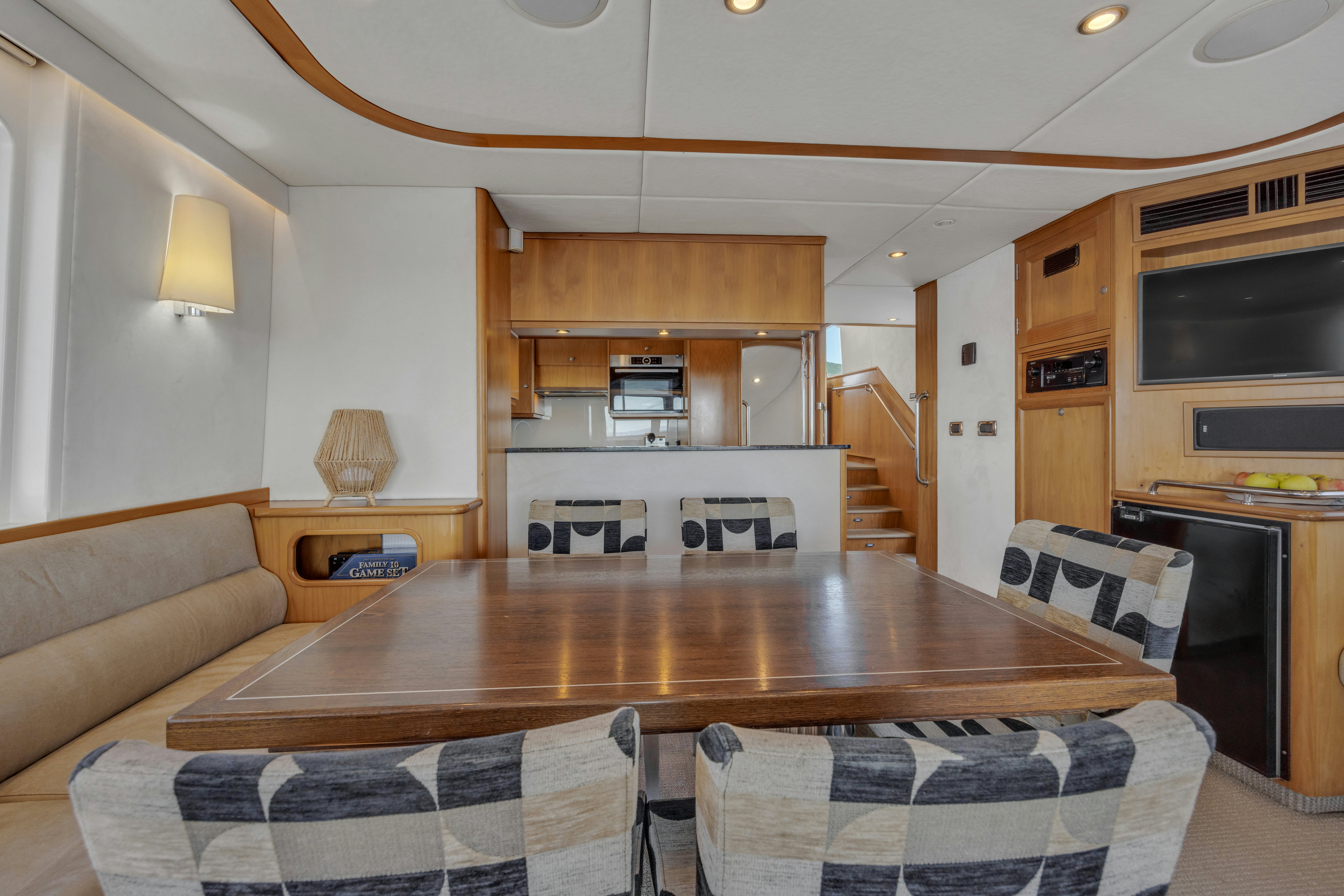 a living room with a table and chairs aboard TASMAN Yacht for Sale