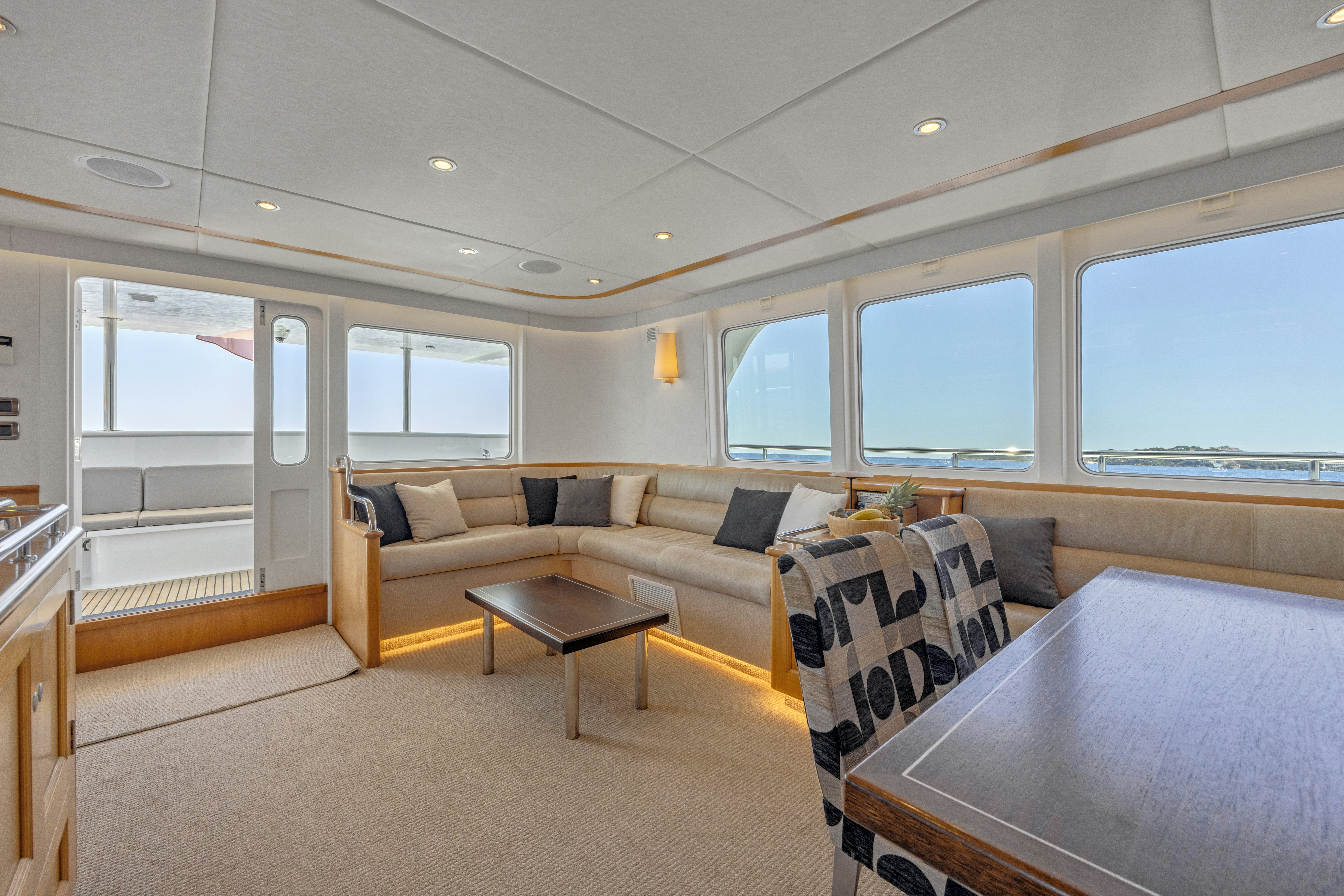 a living room with a couch and a table aboard TASMAN Yacht for Sale